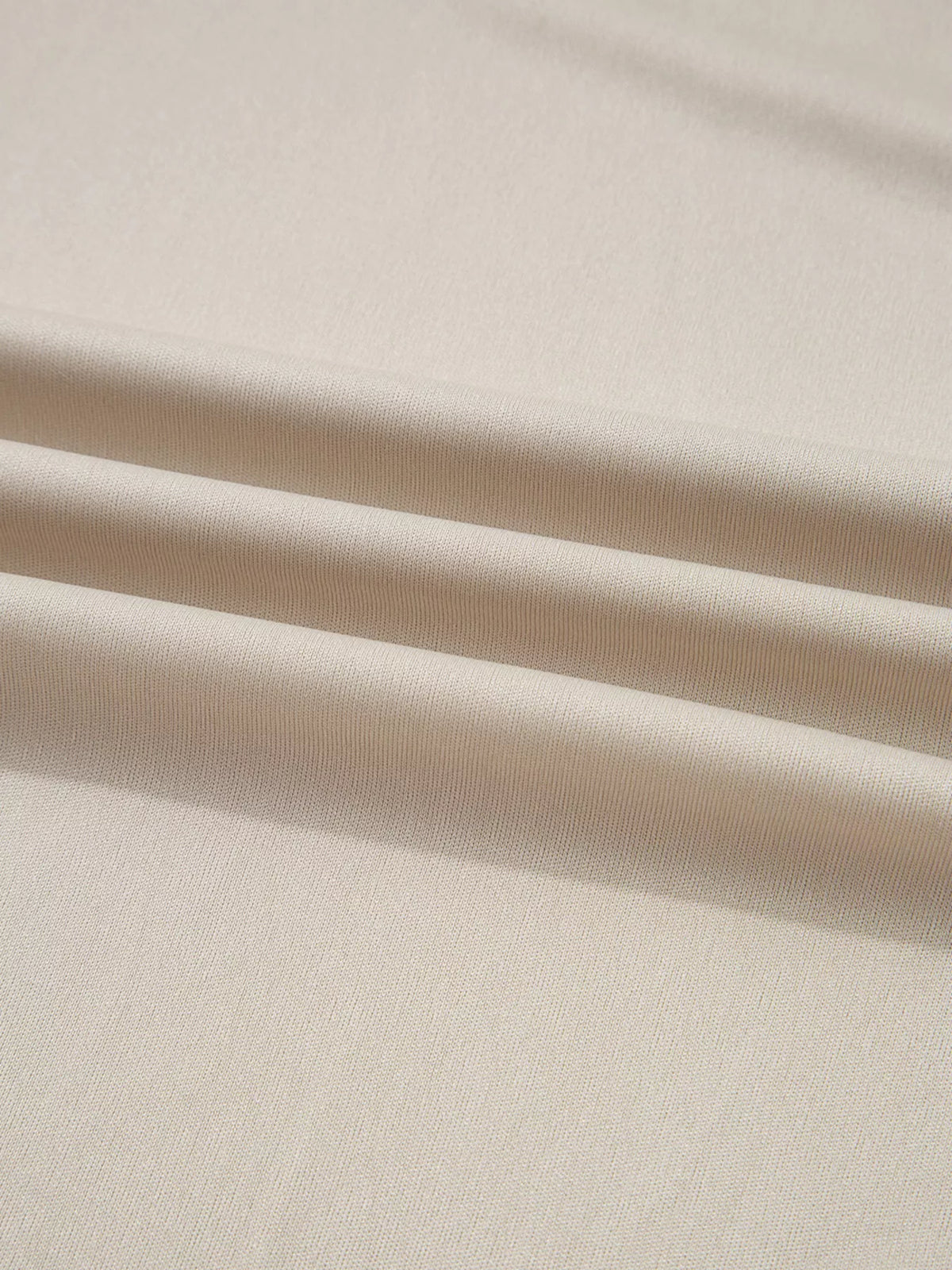Flared midi skirt in taupe tulle mesh, shown in a close-up of its layered fabric