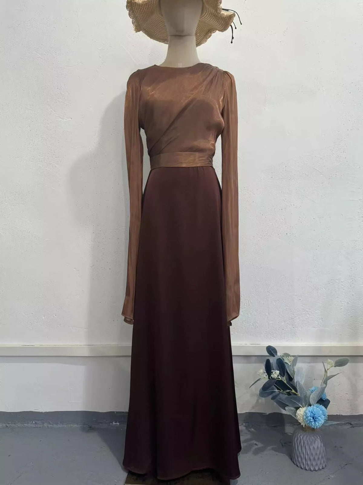 Two-tone maxi dress with a brown top, burgundy skirt, and long straight sleeves