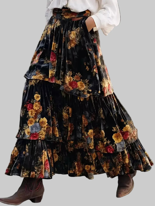 Tiered floral maxi skirt with black background, elastic waist, layered ruffled tiers