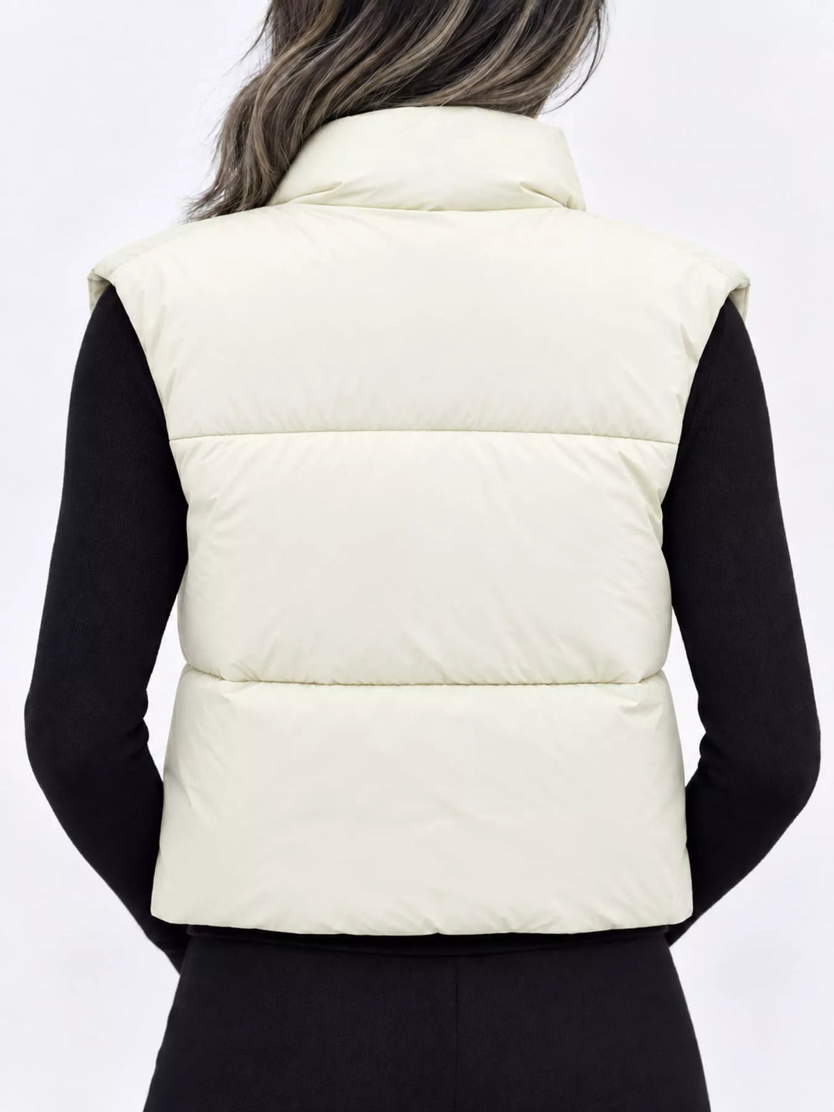 Light cream zip-up puffer vest coat with stand collar, quilted panels, and elastic hem
