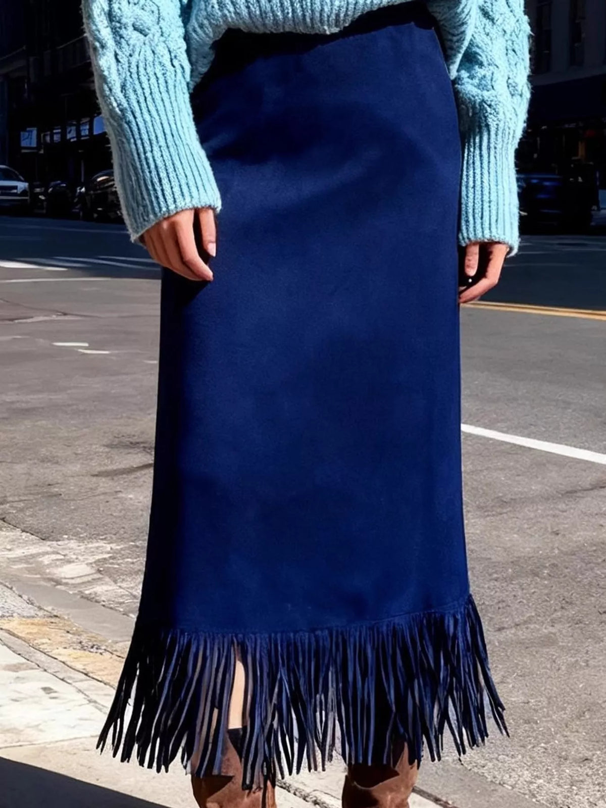 Dark blue high-waisted midi skirt with fringe hem, worn with a sweater