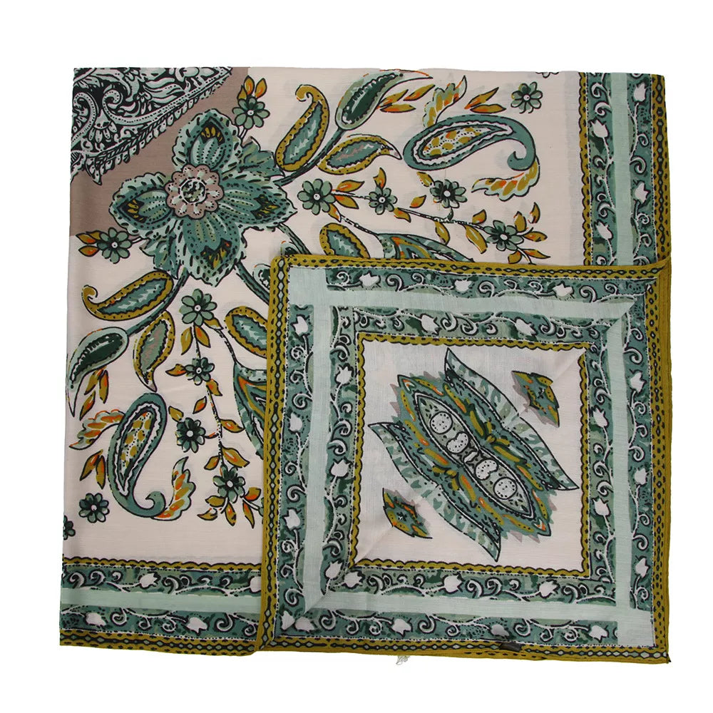 Square silk-feel scarf laid flat, showing green and yellow paisley motifs with a framed center.