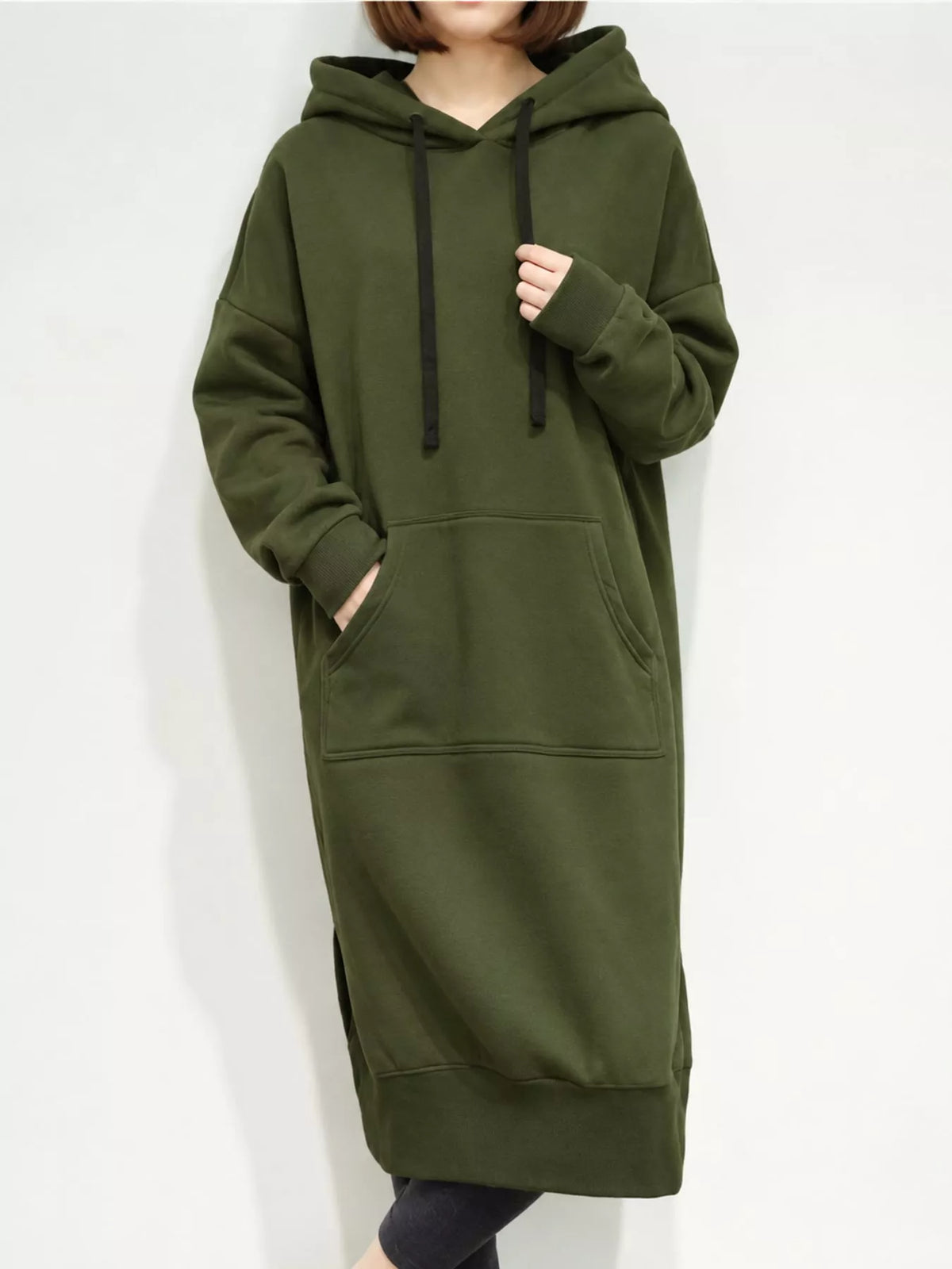 Green hooded sweatshirt dress with drawstrings, long sleeves, kangaroo pocket, and ribbed hem