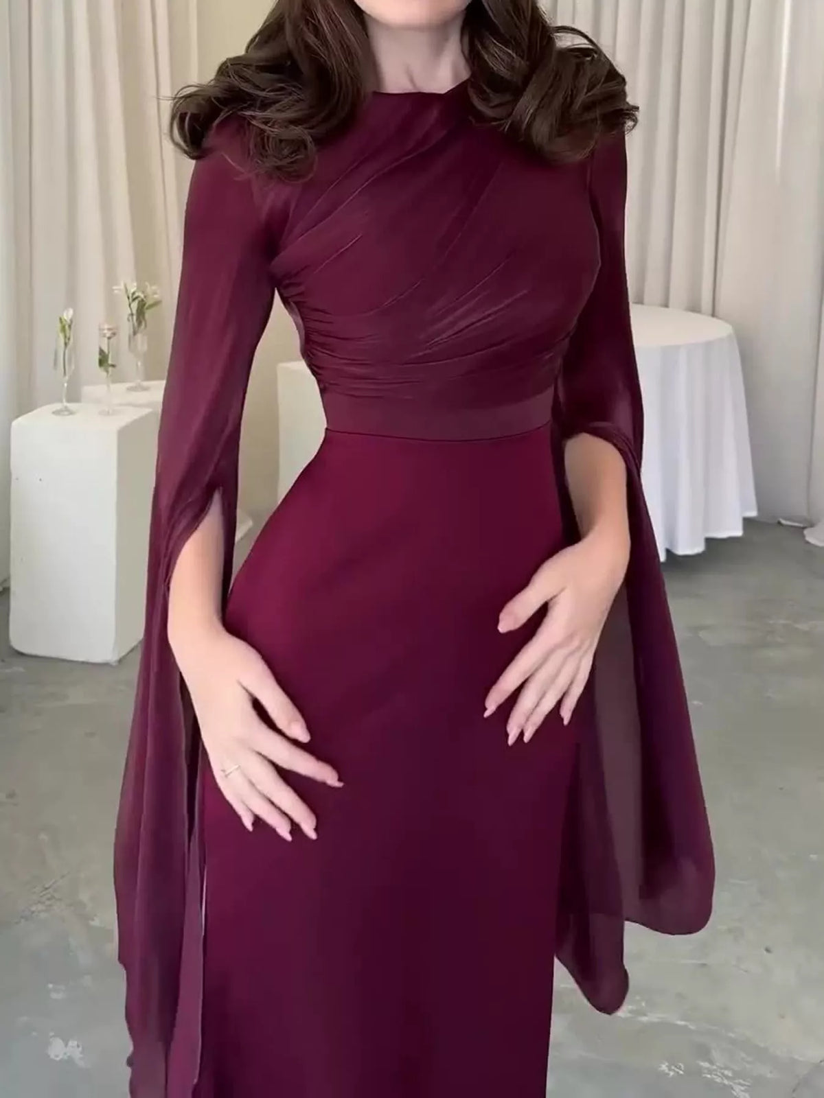 Burgundy dress with diagonal ruching and long open flare sleeves