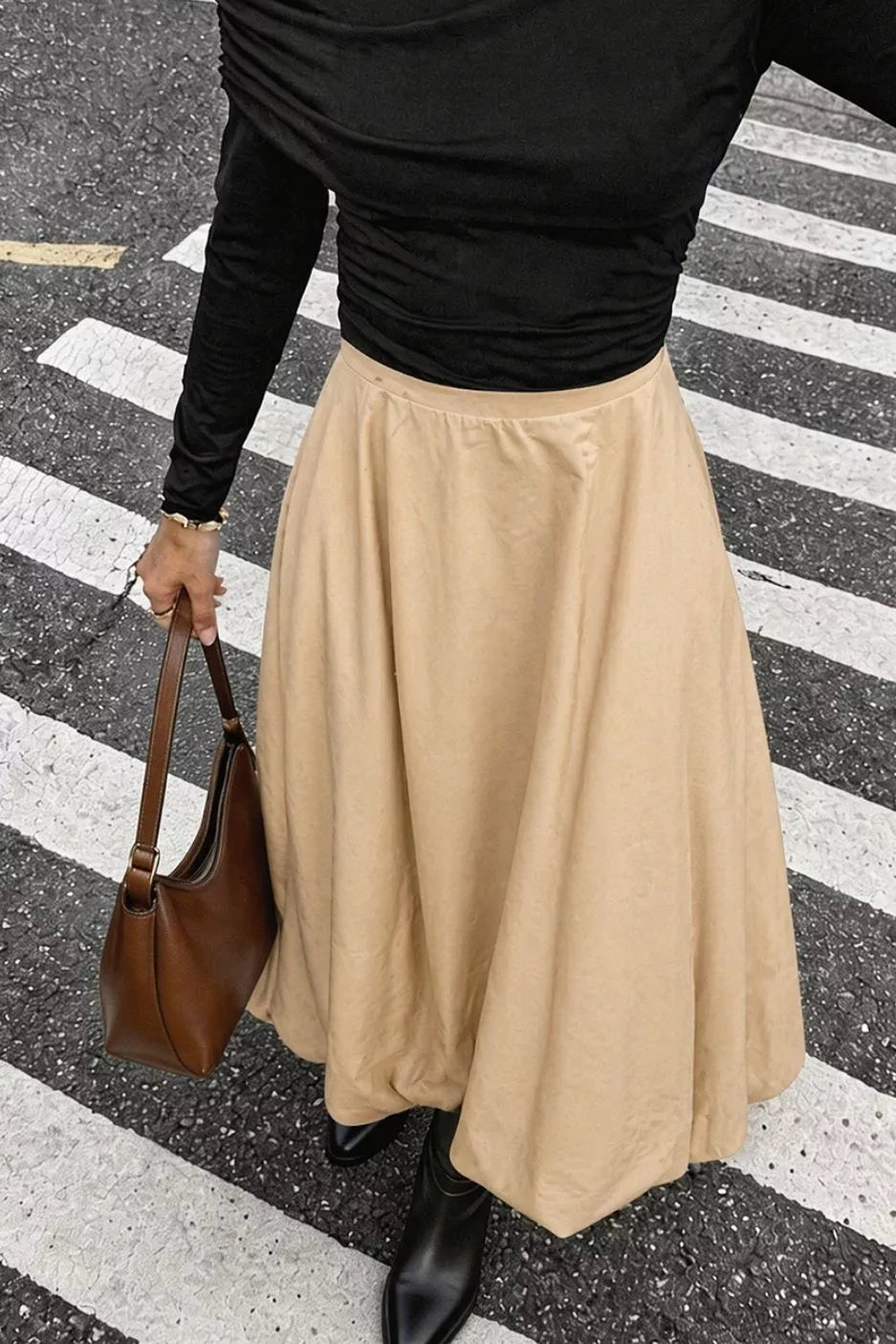 Tan high-waisted midi skirt with a gently flared silhouette.
