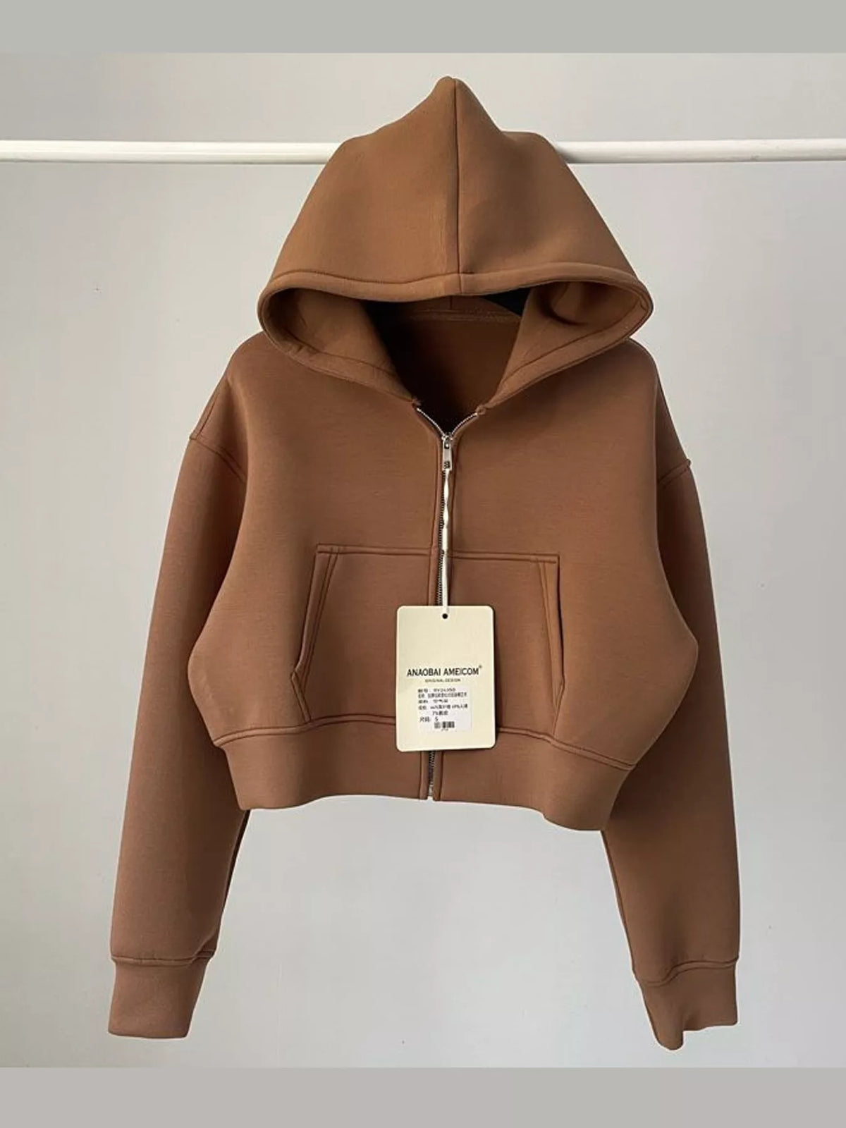 Mocha brown cropped zip-up hoodie with hood, front zipper, and kangaroo pocket.