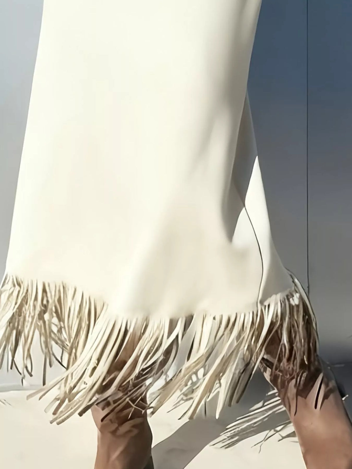 Off-white suede high-waisted midi skirt with layered fringe hem detail