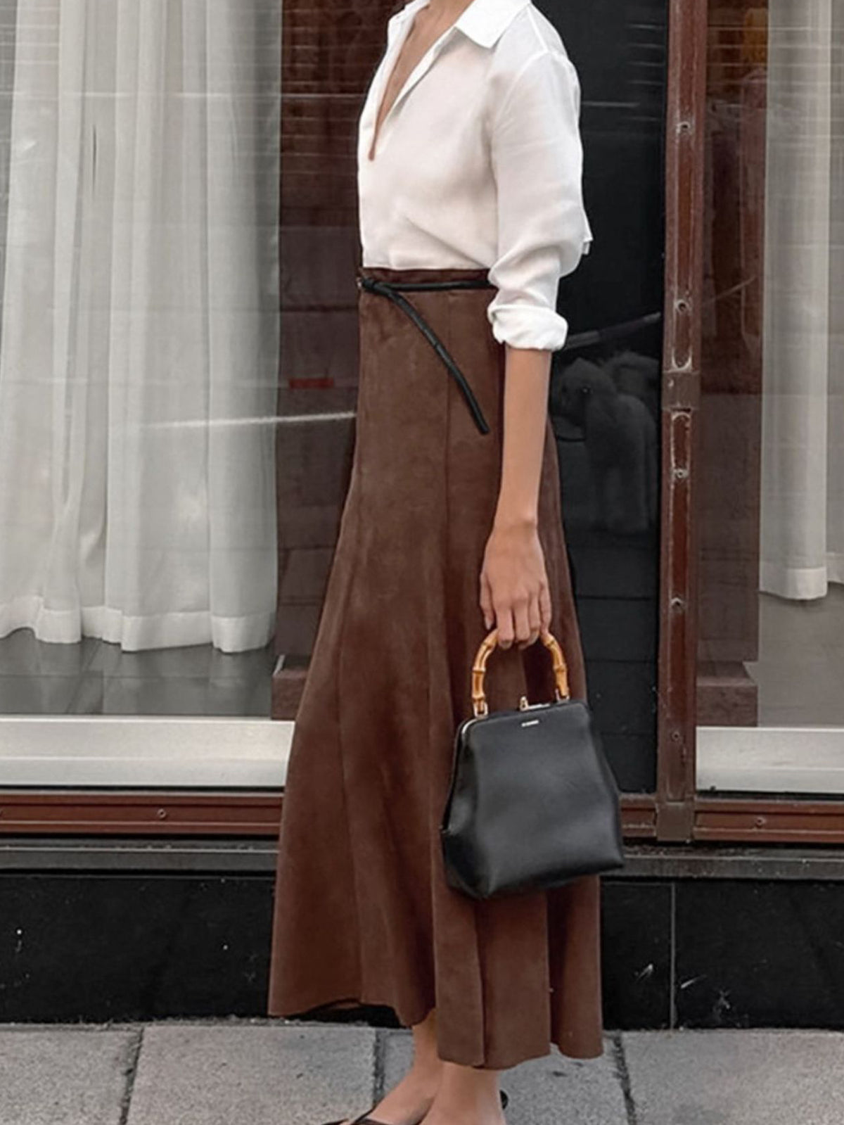 Side view of the dark brown suede midi skirt with a slim belt