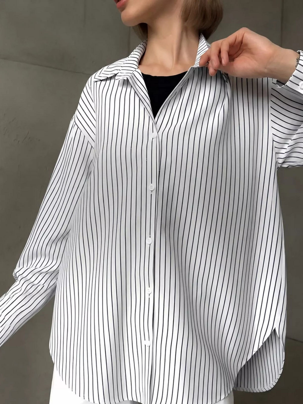 Black and white vertical striped button-up long sleeve shirt with point collar and buttons