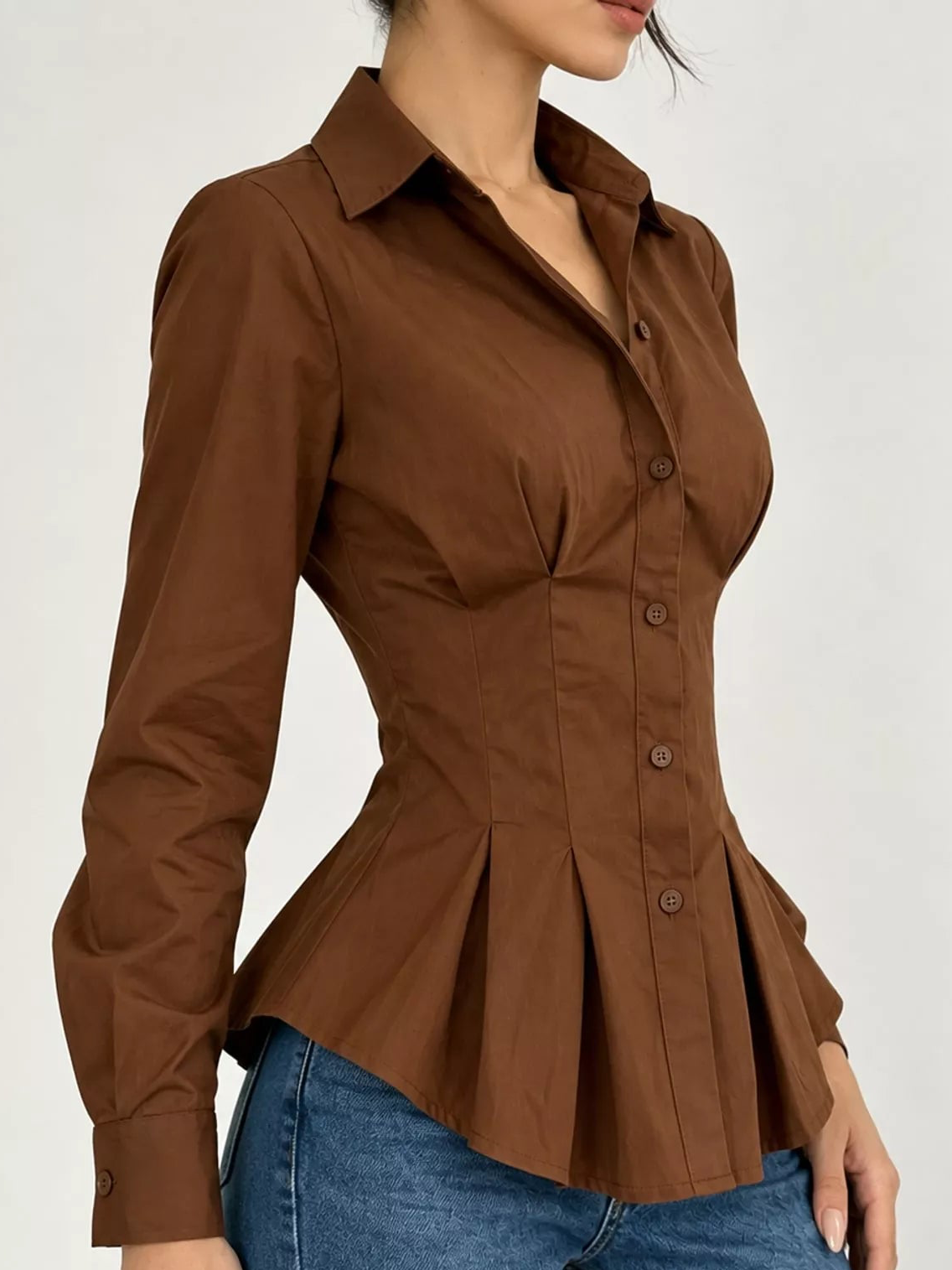 Dark brown button-down peplum blouse with fitted waist and long sleeves, side peplum flare
