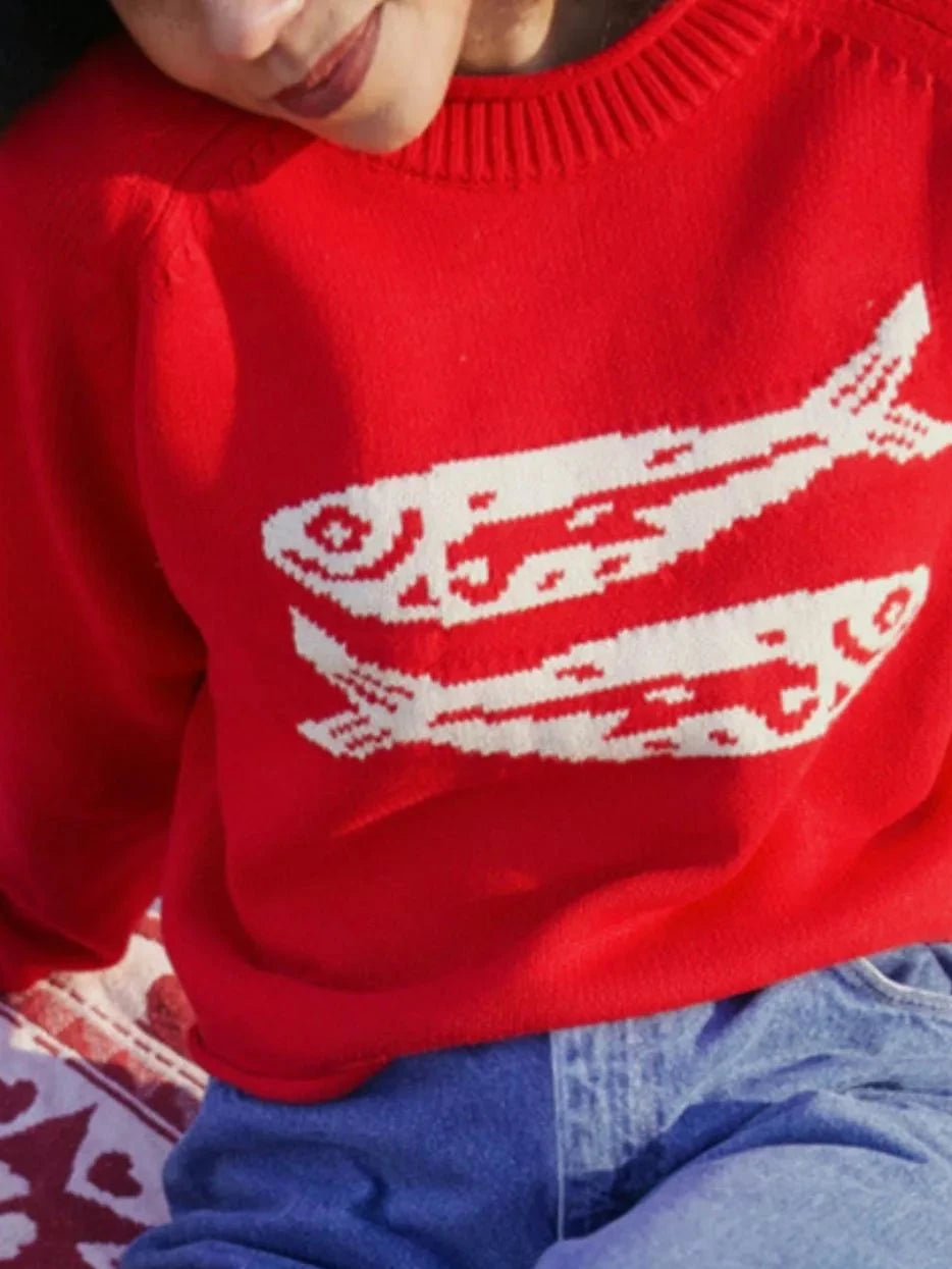 Red crew neck sweater with white fish-pattern yoke detail and ribbed cuffs