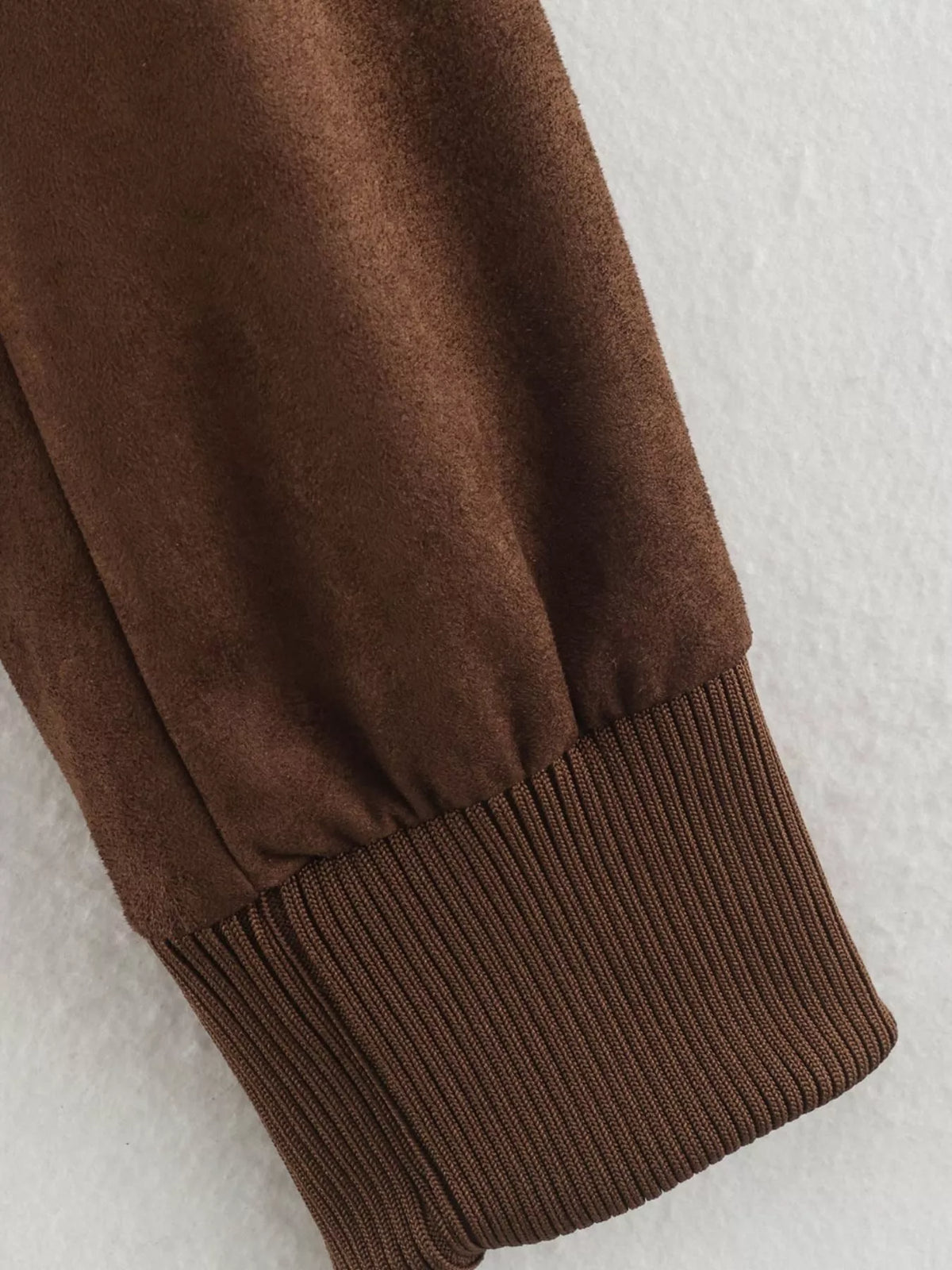 Brown long sleeve jacket cuff with ribbed knit hem and elasticated sleeve band