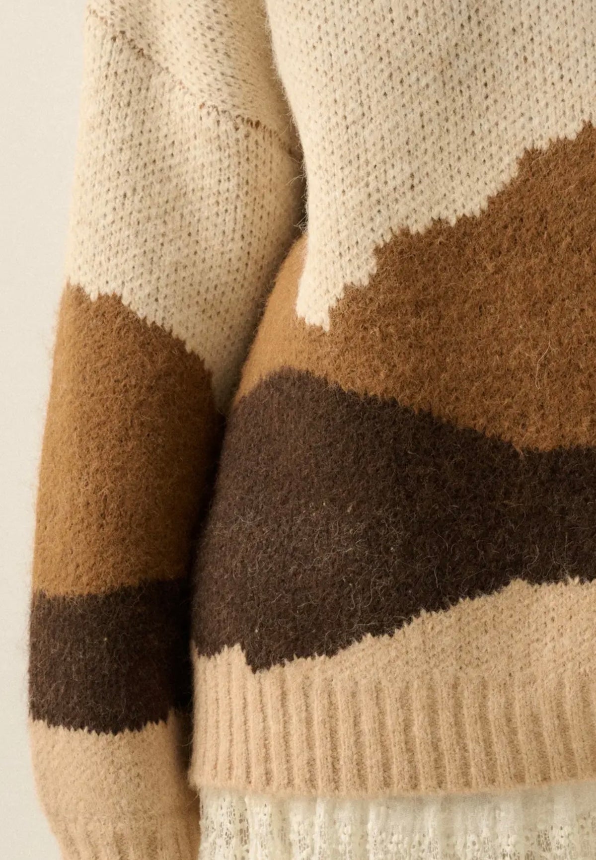 Fuzzy knit crewneck sweater sleeve, cream with brown and dark stripe blocks
