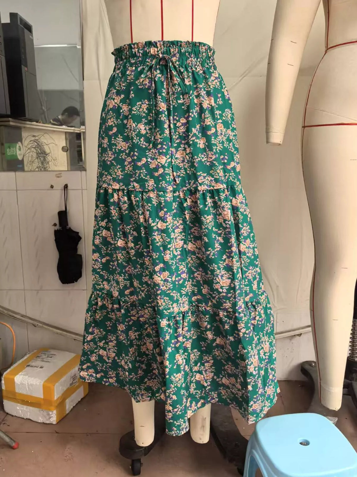 Floral tiered midi skirt in deep green with pink and cream blossoms, gathered tiers