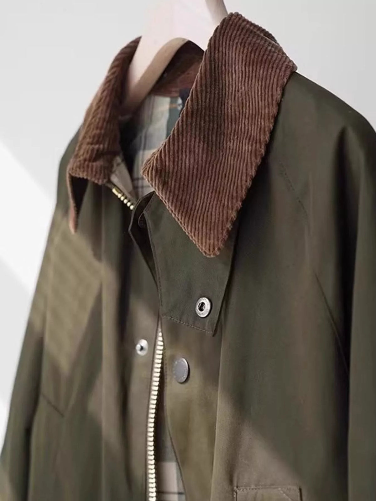Brown corduroy collar on sage green zip-up jacket with snap front