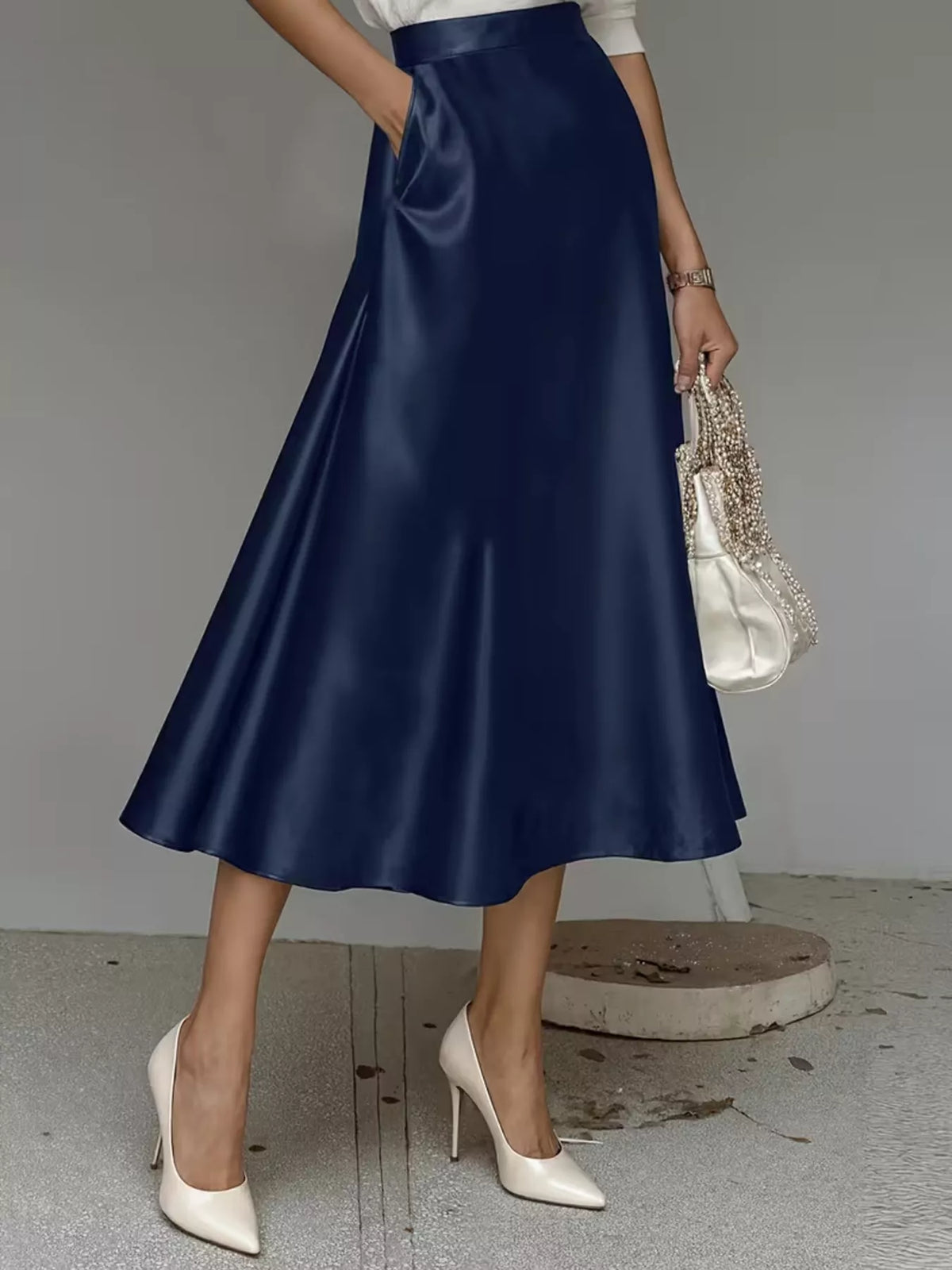 Navy satin midi skirt with a high waist and flared hem