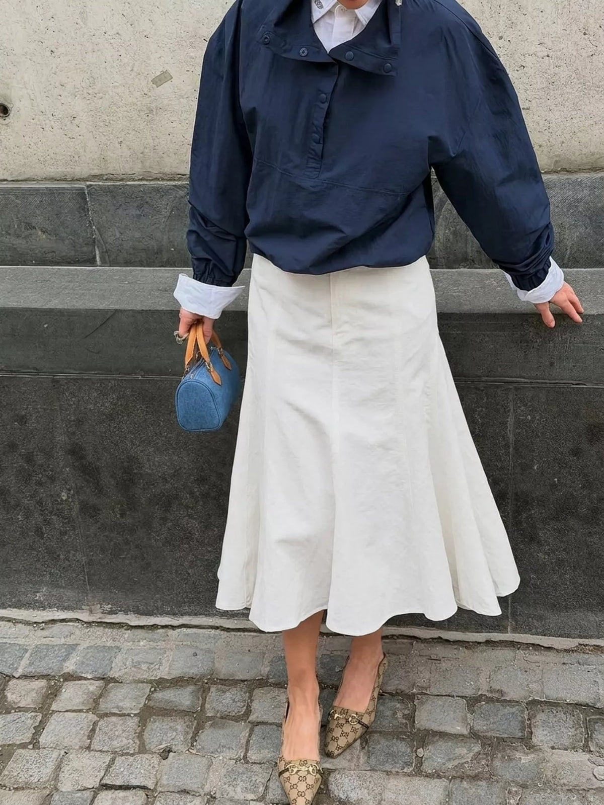 White mermaid midi skirt with a high waist, shown from the front on a model