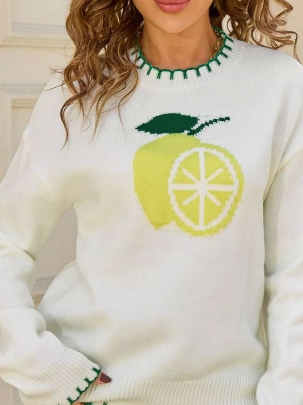Cream lemon graphic sweater with green round-neck trim and yellow-green print