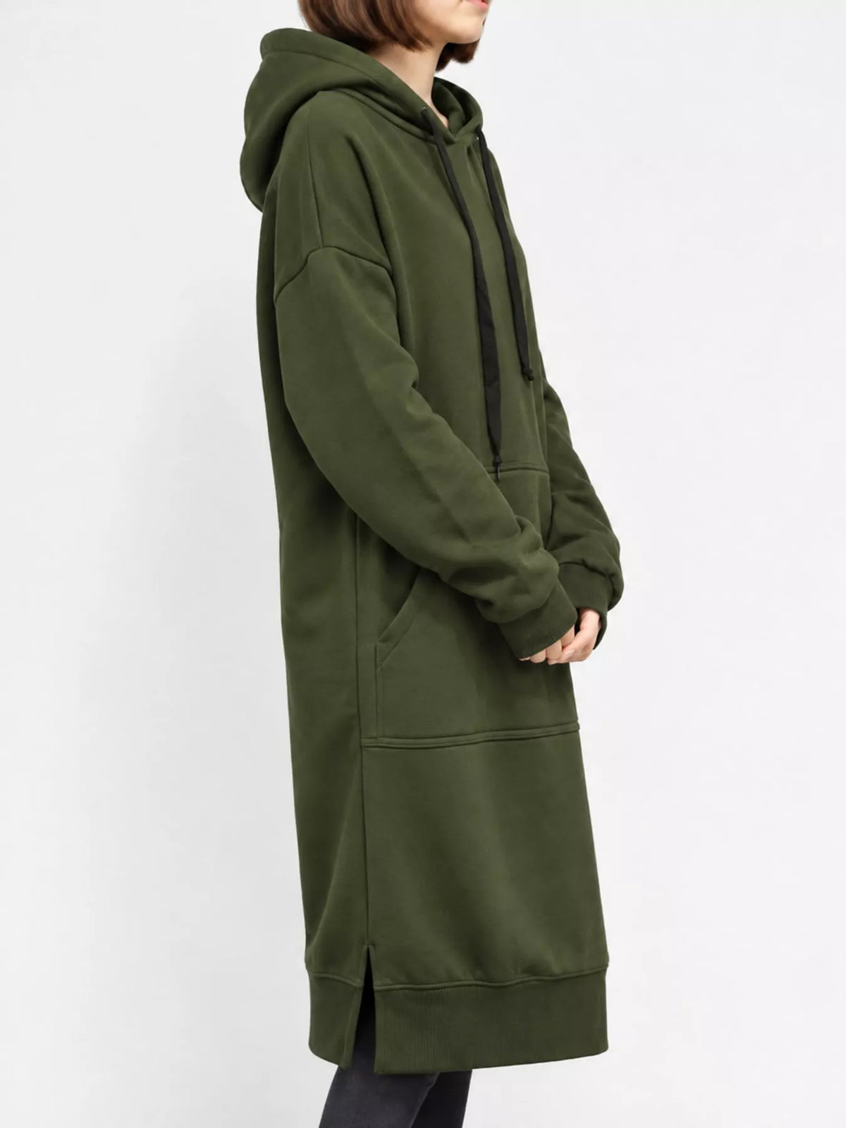 Green sweatshirt dress shown from the side, with hood, kangaroo pocket, and side slit
