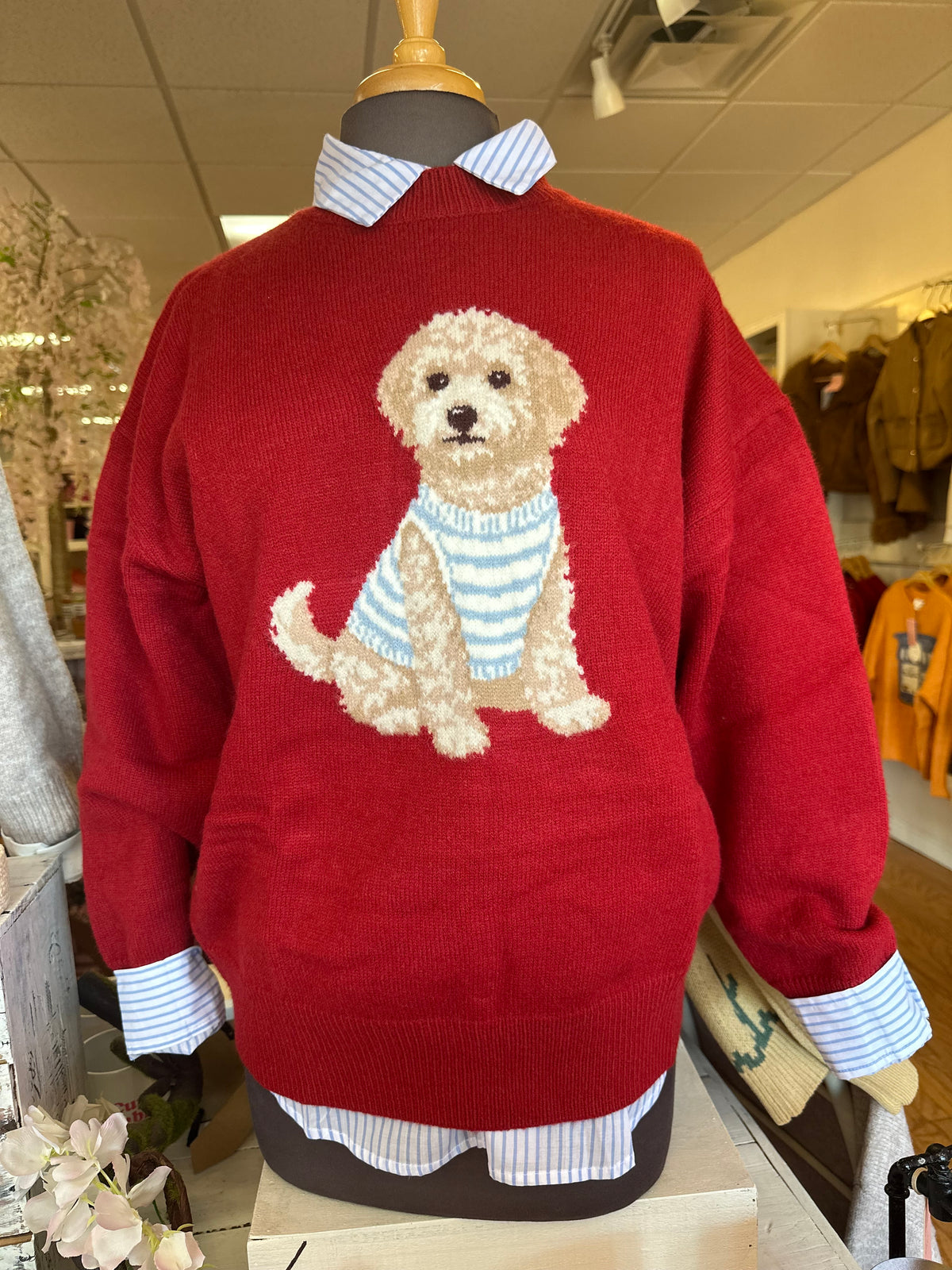 Red sweater with dog graphic and striped collar and cuffs