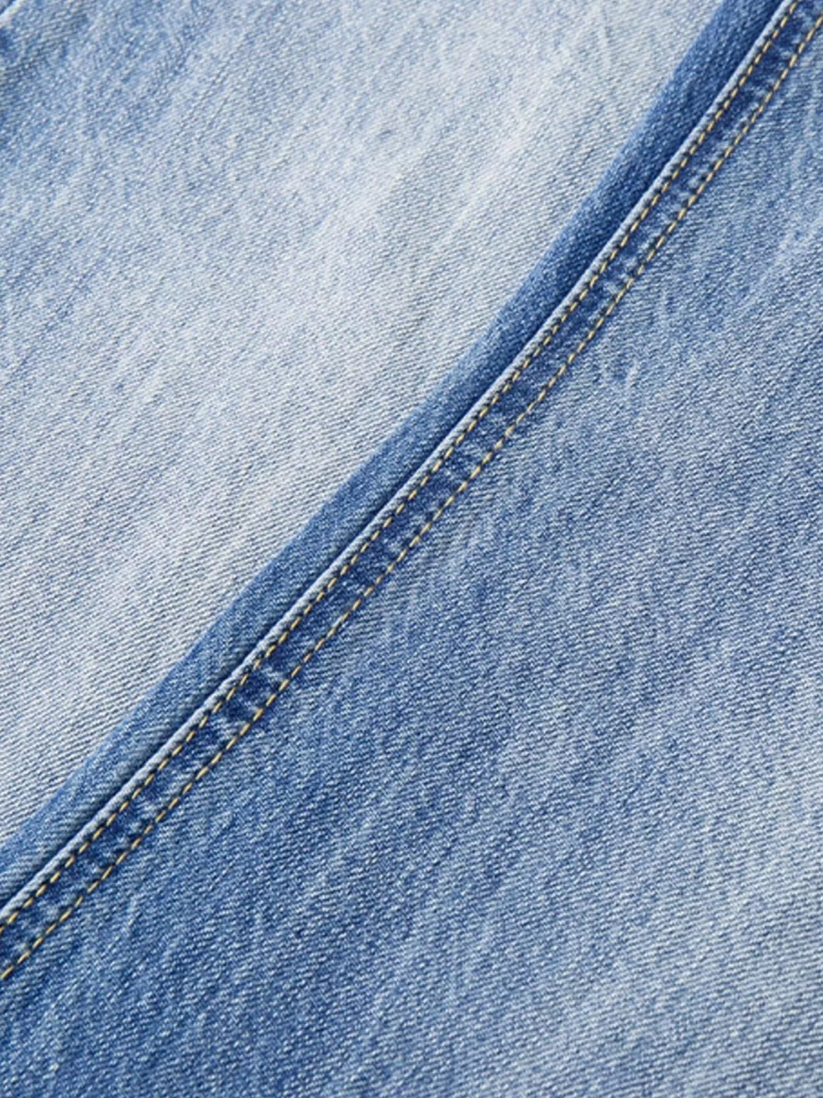 Vintage-wash denim close-up showing stitched seam detail