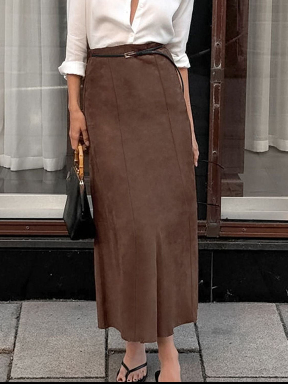 Dark brown suede midi skirt modeled with a slim belt