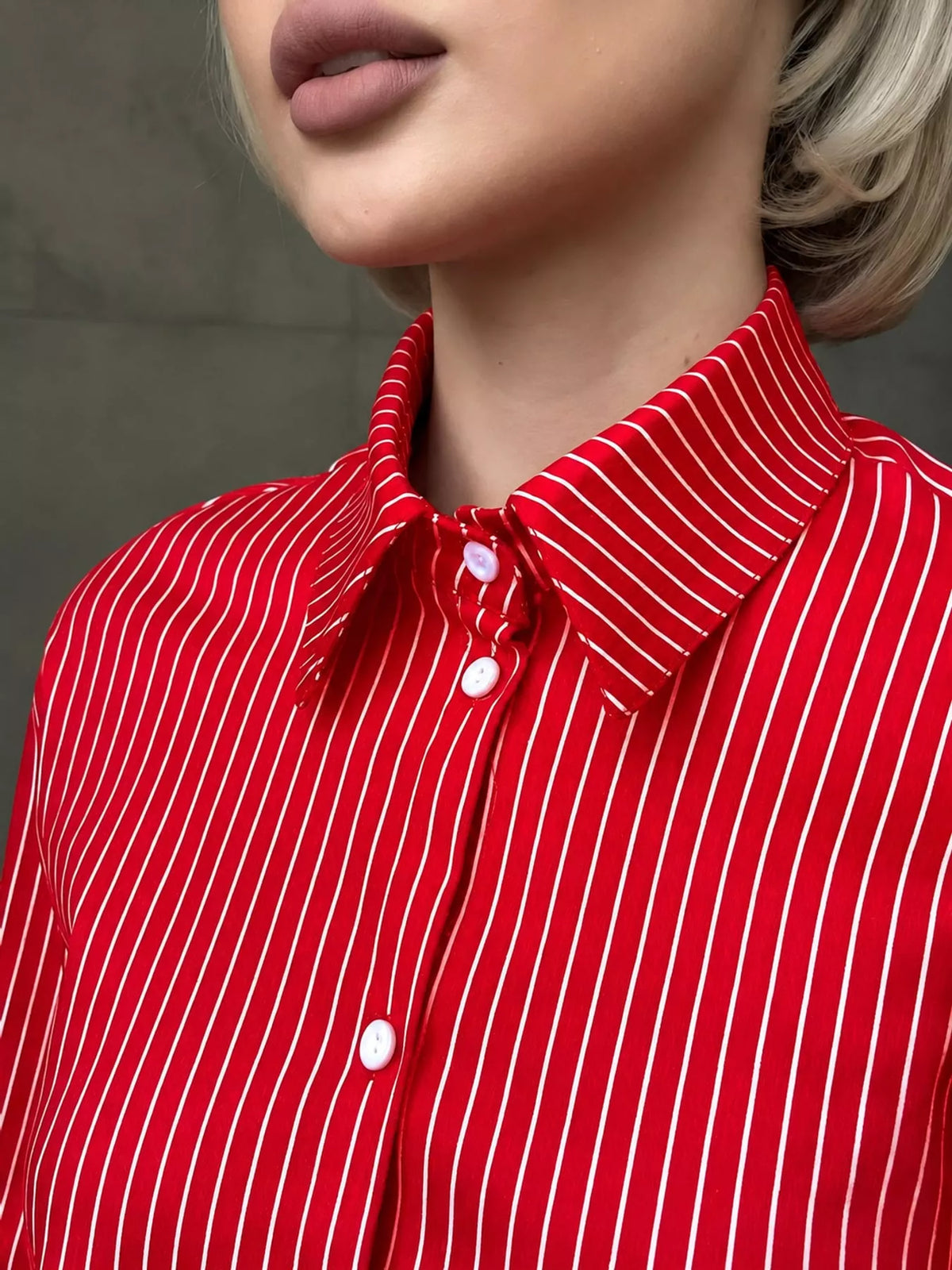 Red and white striped long-sleeve button-up shirt collar with button placket