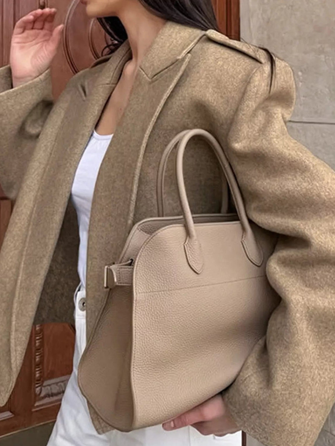 Brown cropped blazer shown from the side, with shoulder epaulettes and long sleeves