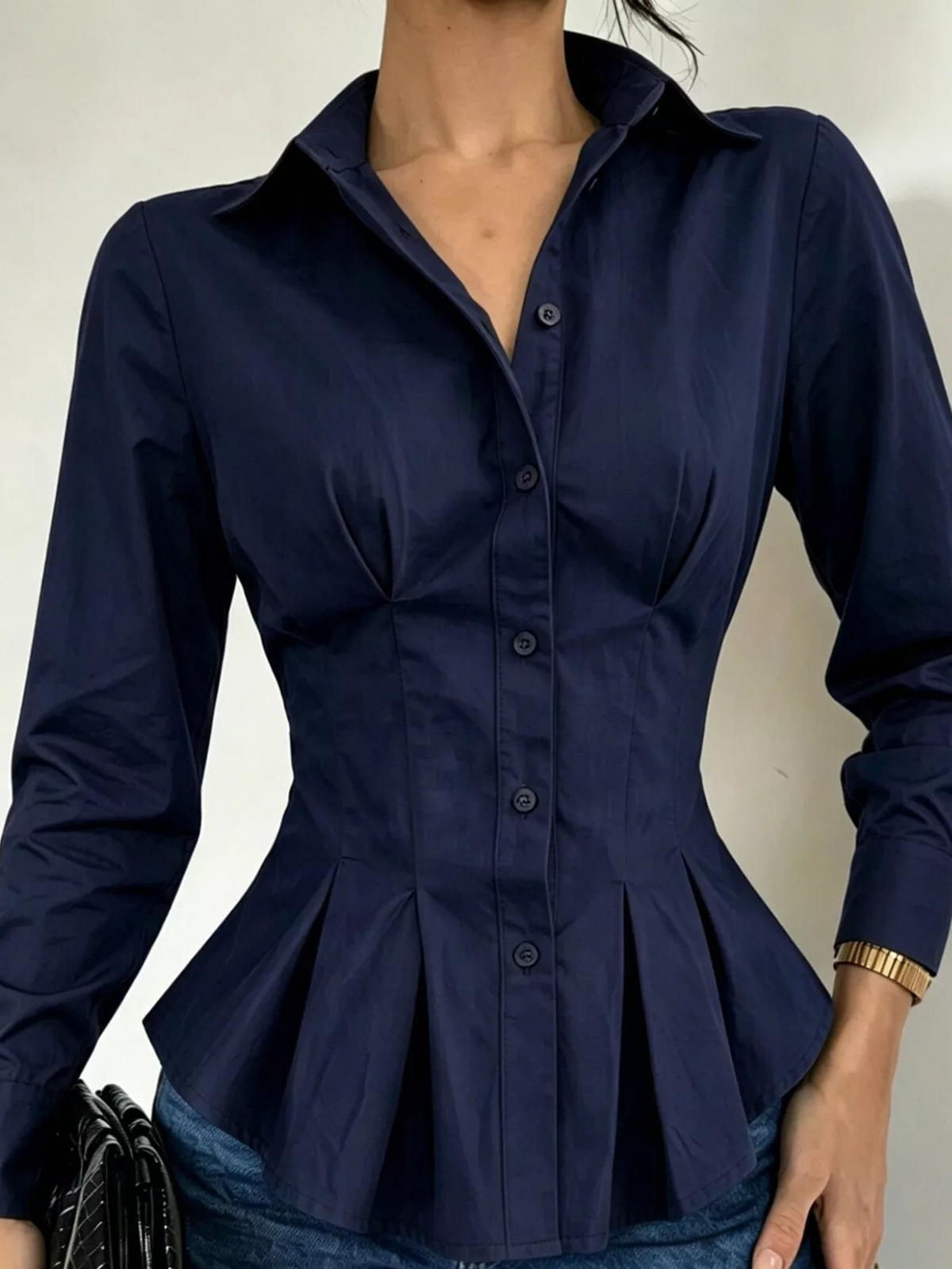 Navy button-down peplum blouse with fitted waist, long sleeves, front buttons