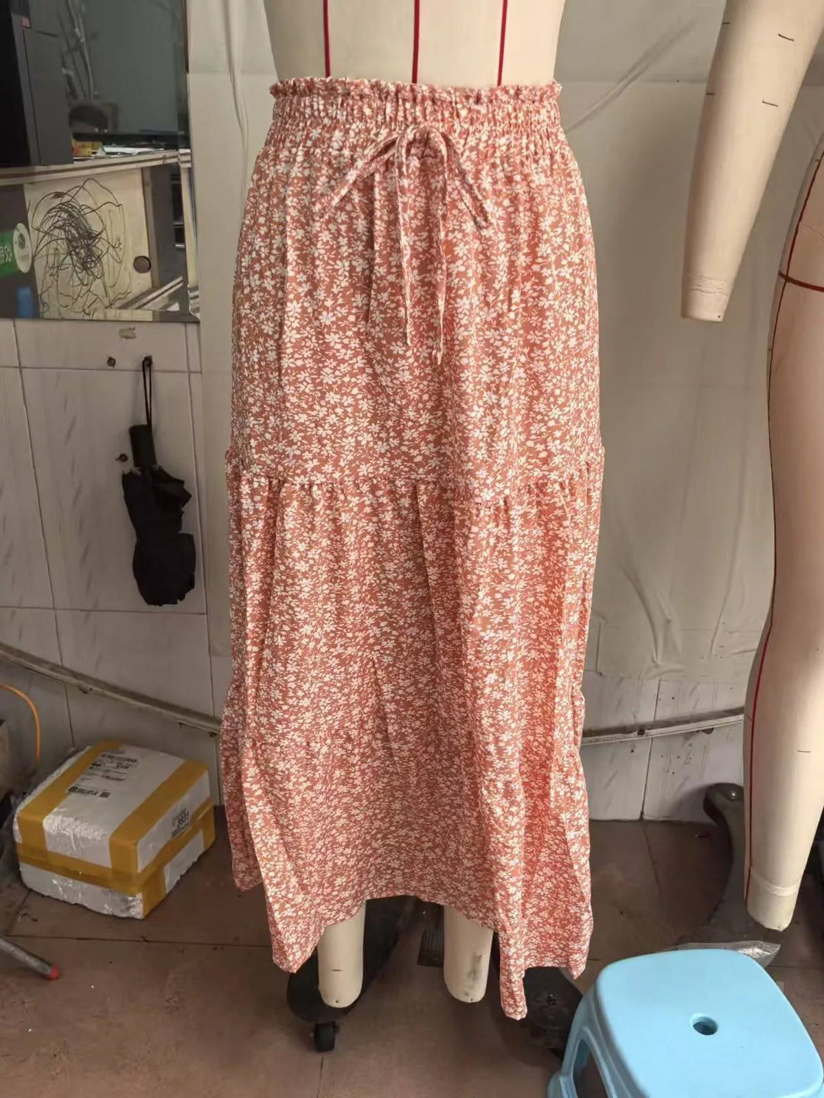 Coral floral tiered midi skirt with elastic waistband and tie drawstring, tiered ruffle layers.