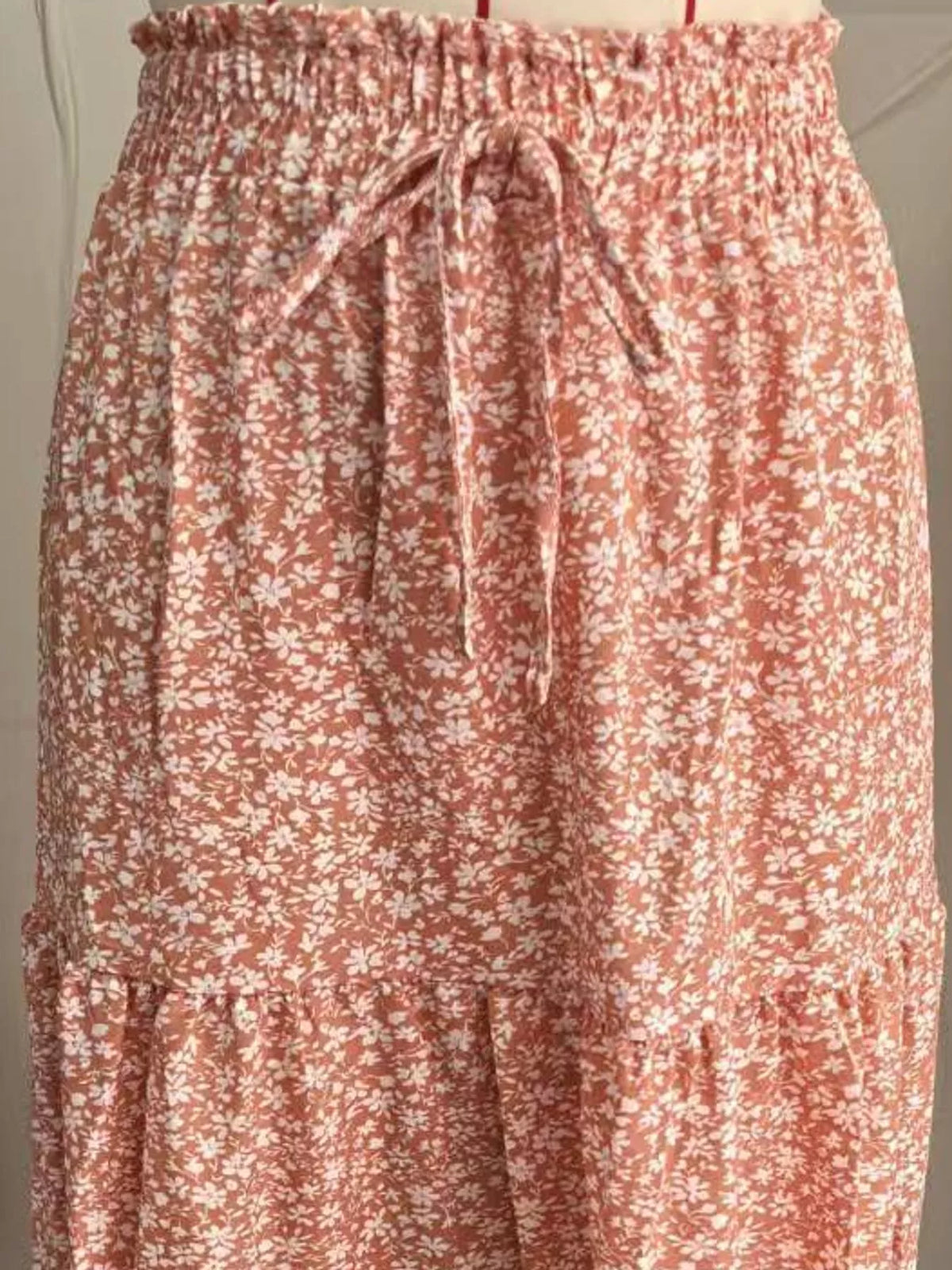 Coral and white floral tiered midi skirt with elastic waistband and front tie drawstring.