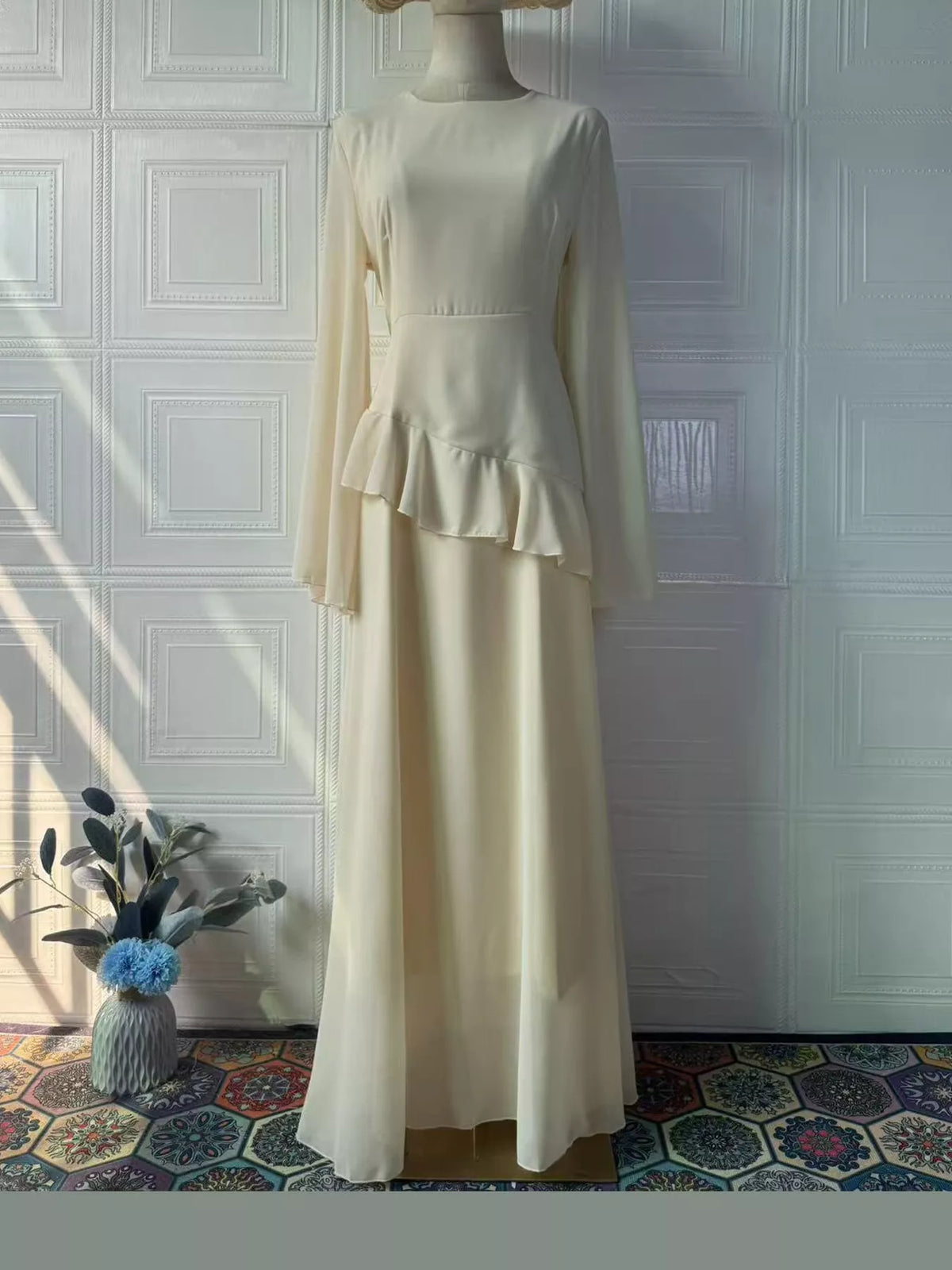 Pale cream ruffled maxi dress with long sleeves and layered ruffle skirt