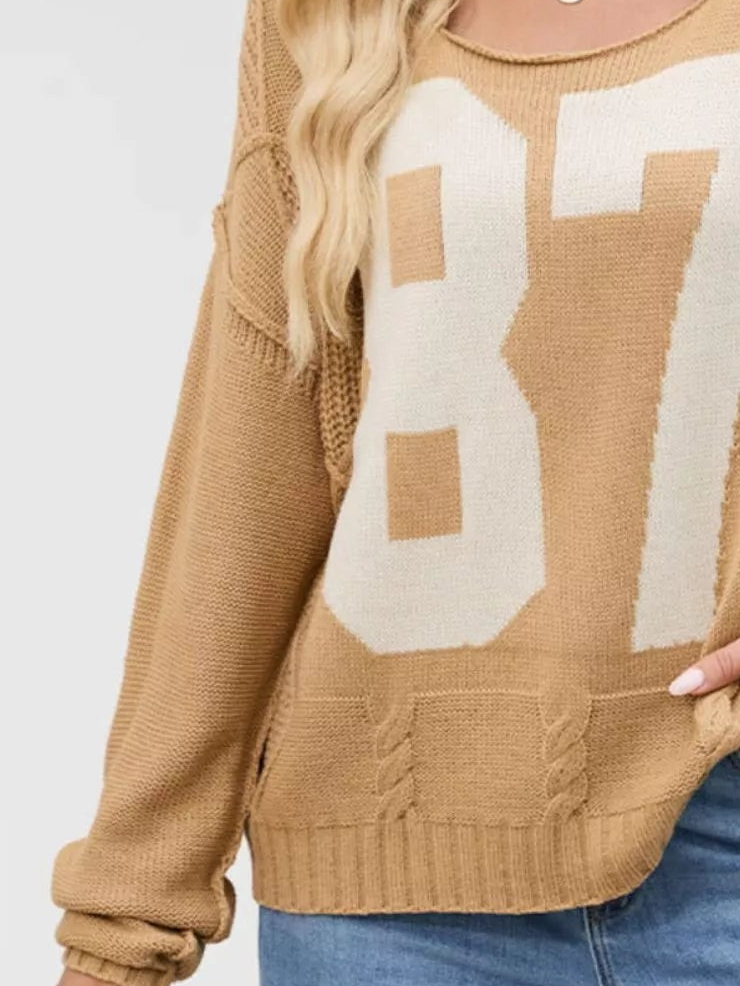 Tan cable-knit sweater with cream 87 number graphic, long sleeves, ribbed hem
