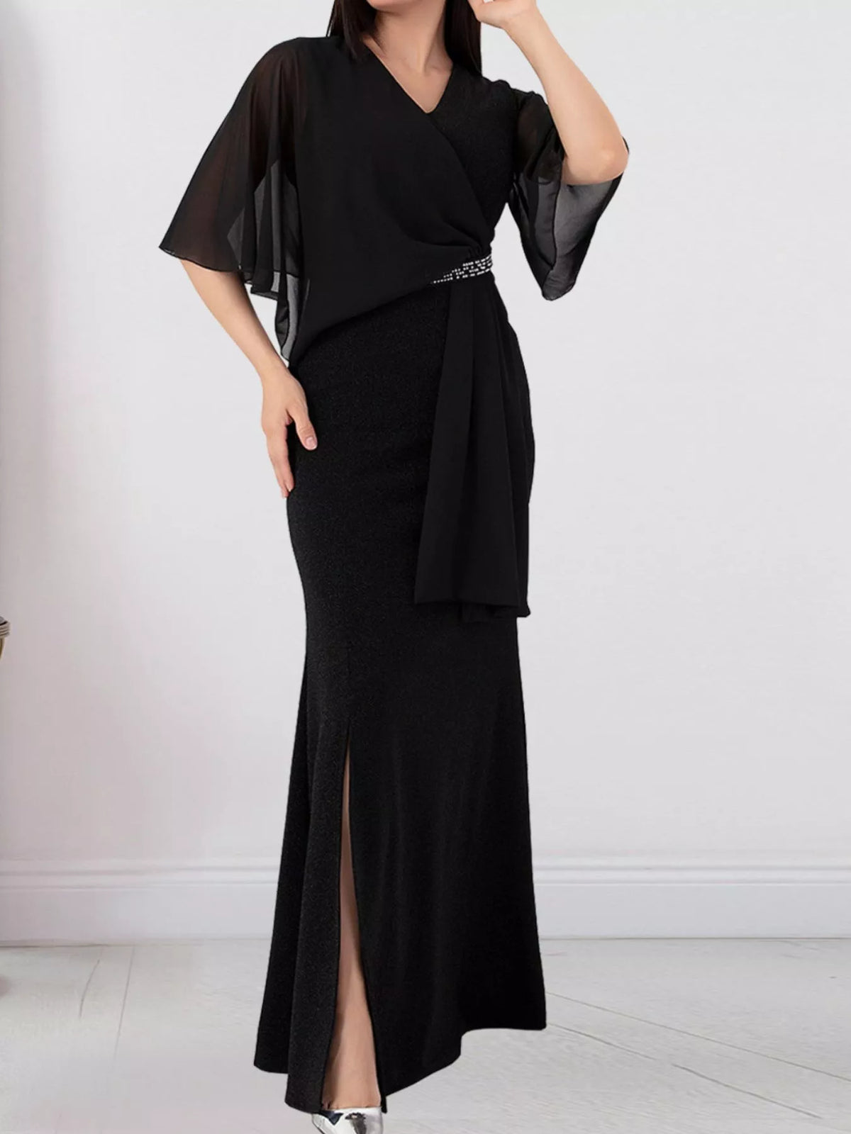 Black slit maxi dress with flutter sleeves and waist tie, draped wrap front