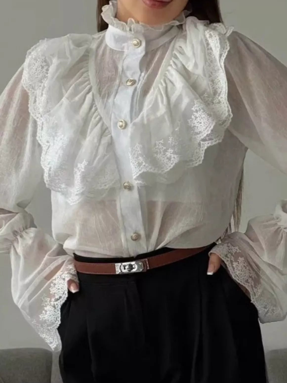 White lace button-up shirt with a ruffled front and wide lace-trimmed cuffs