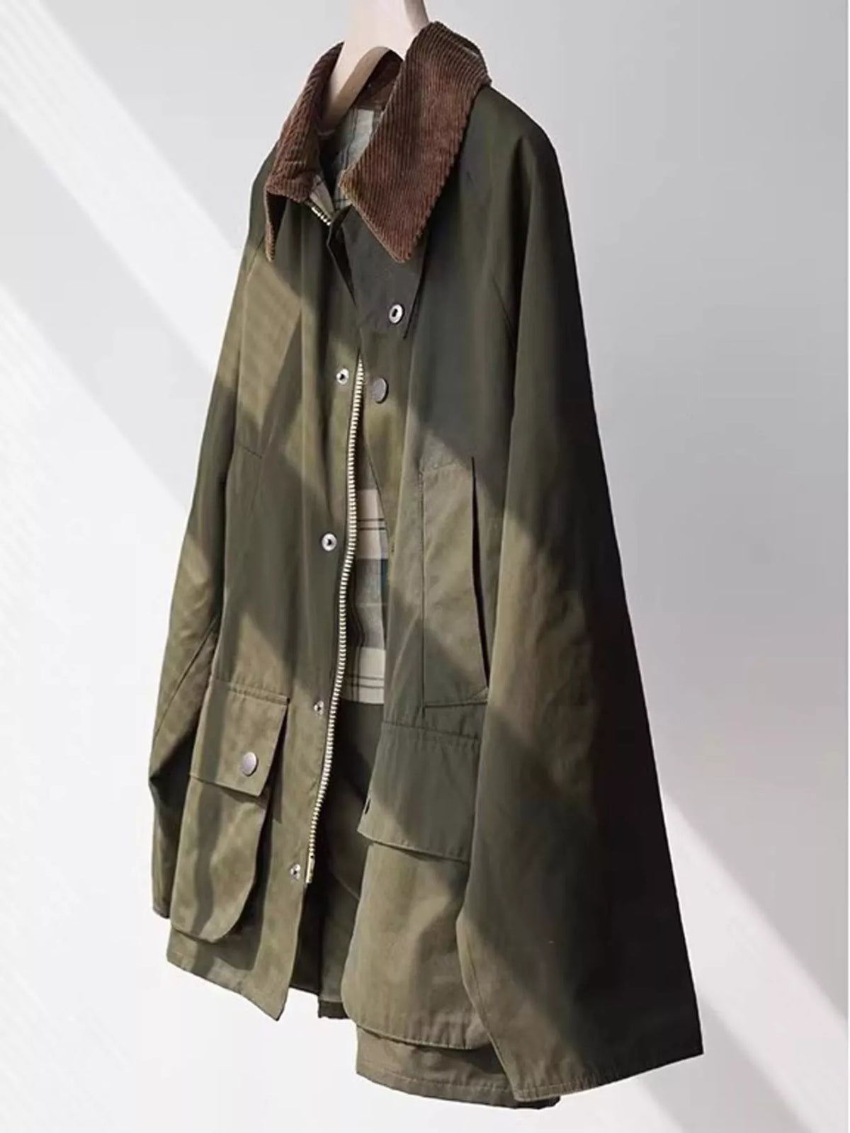 Sage green zip-up jacket with brown corduroy collar and front pockets