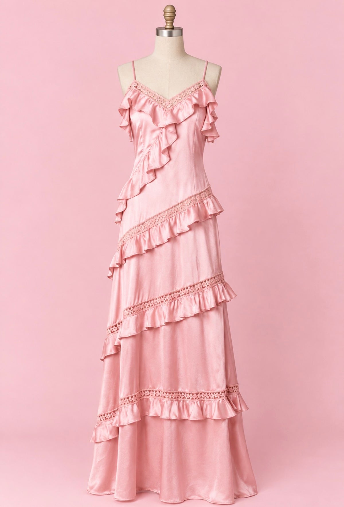 Pink satin maxi dress on mannequin with tiered ruffle lace trim and spaghetti straps