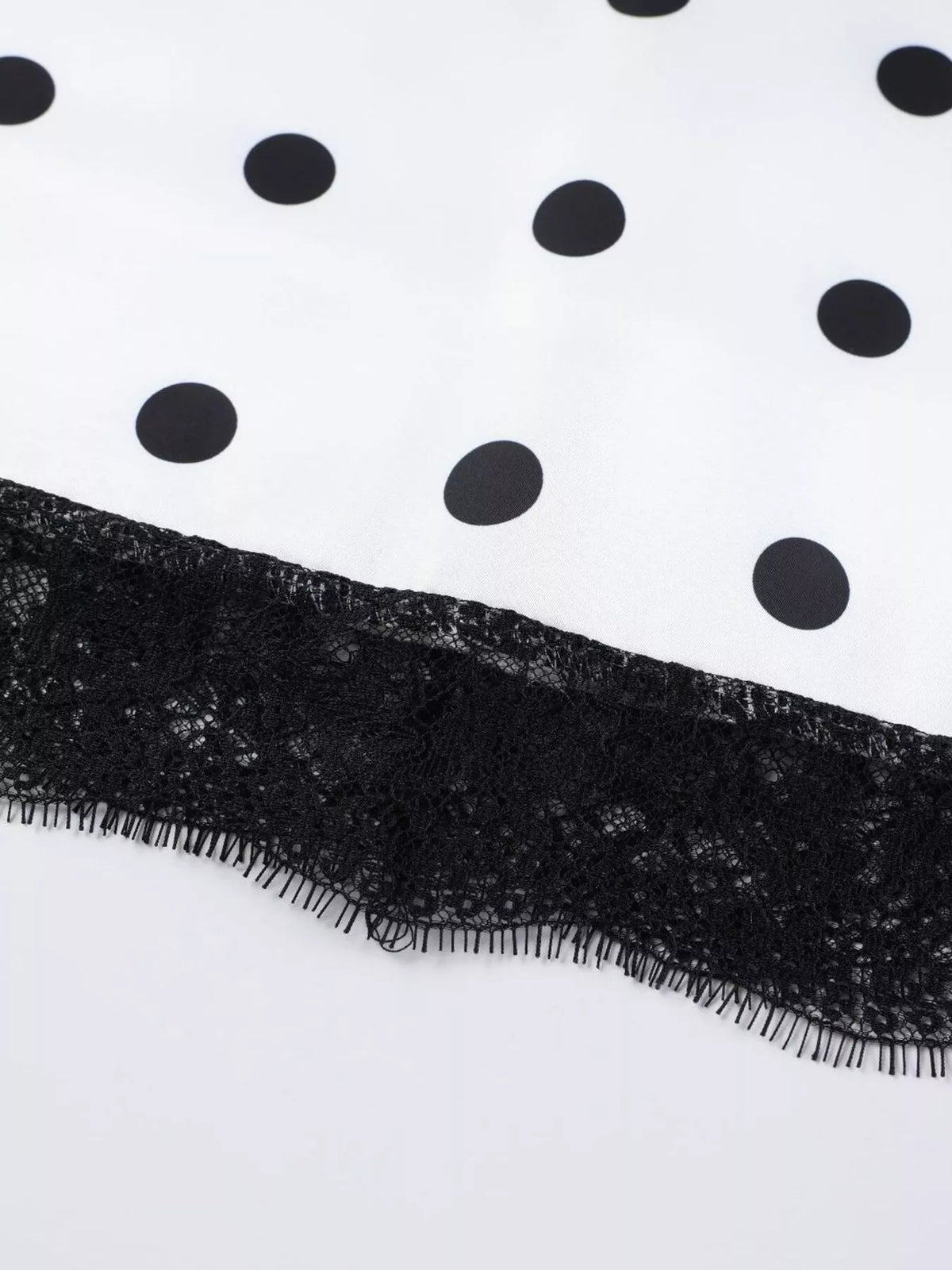 White polka dot midi skirt finished with a wide black lace hem