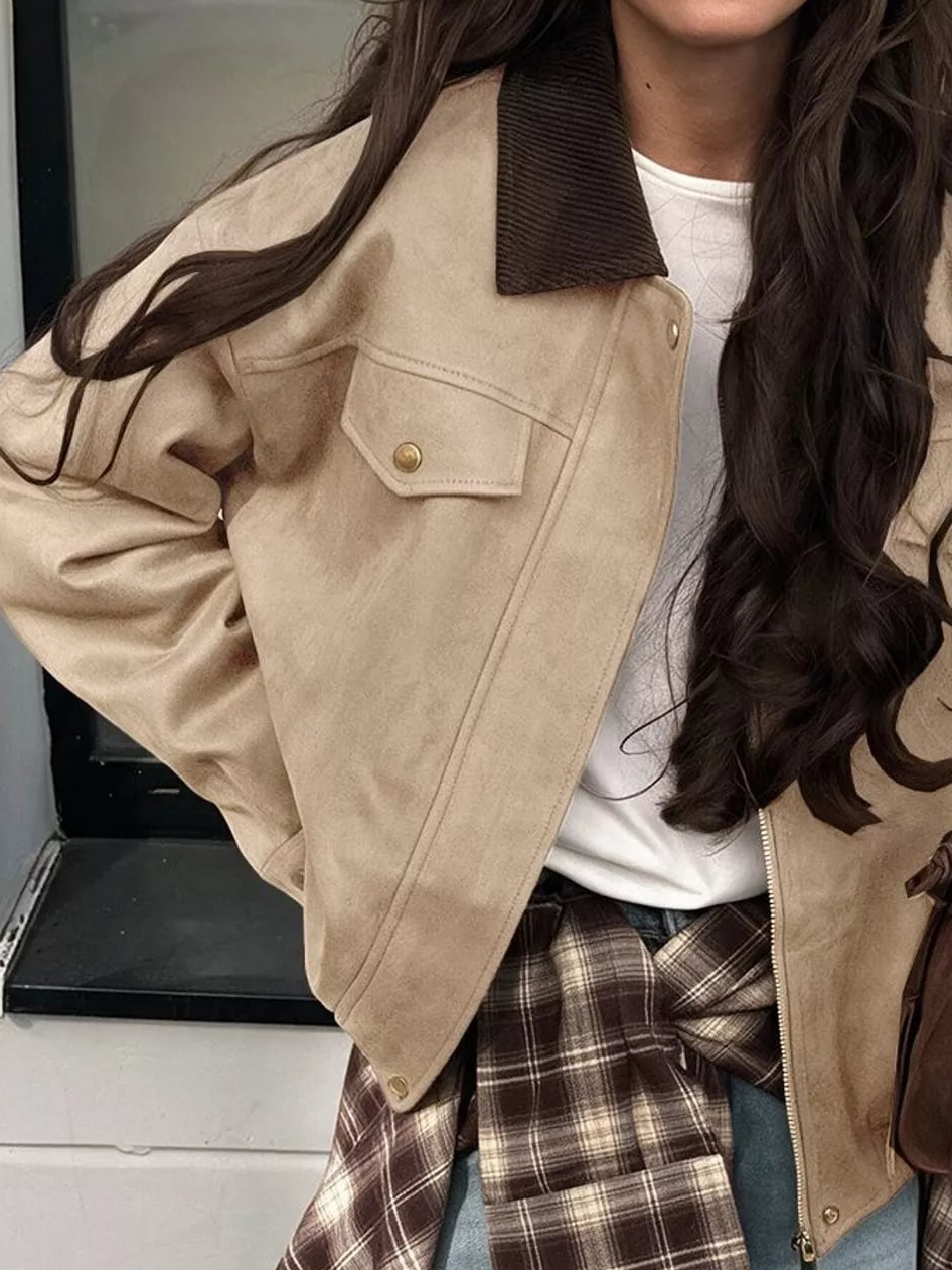 Apricot/beige zip jacket with dark collar, front snap pockets, and stand-up collar tabs
