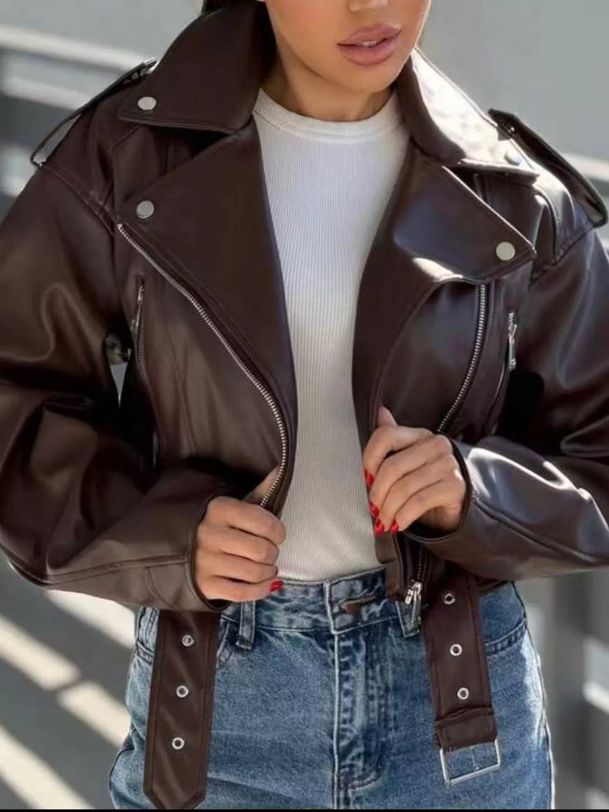 Dark brown faux leather zip-up jacket with snap cuffs and front zipper details