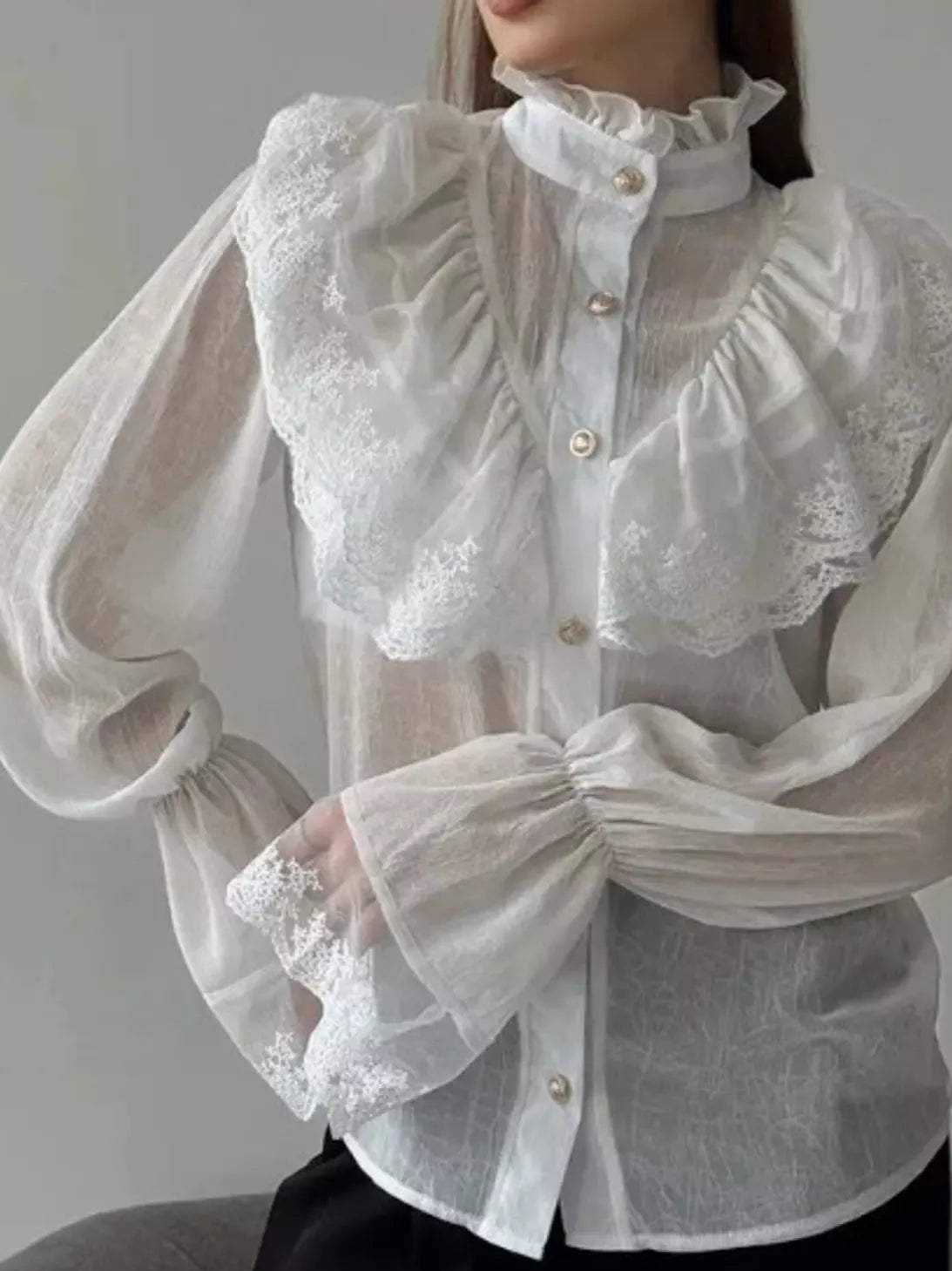White sheer lace button-up shirt with a ruffled bib, high collar and flounce sleeves