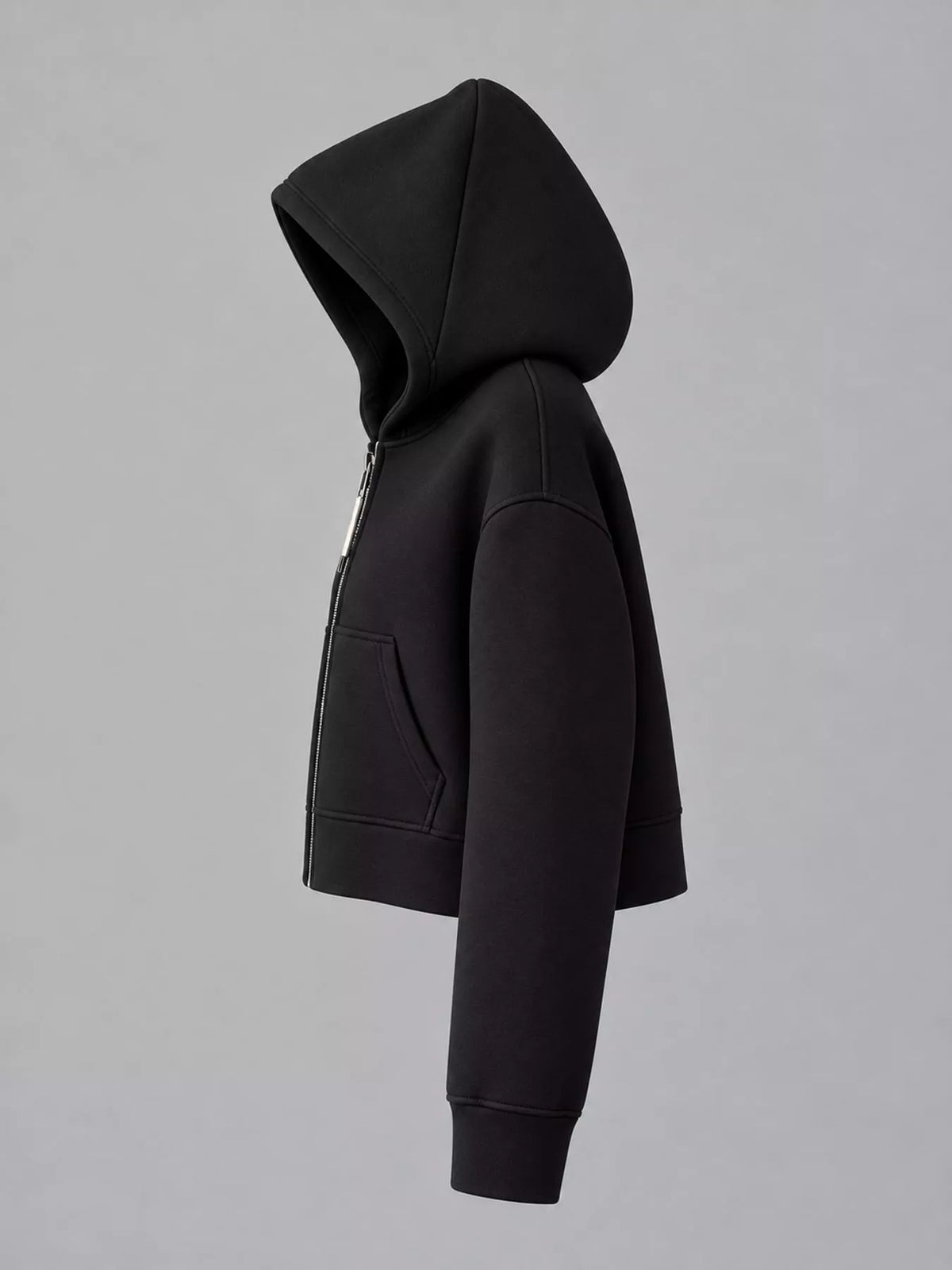 Black cropped zip-up hoodie with hood and kangaroo pocket, side view.
