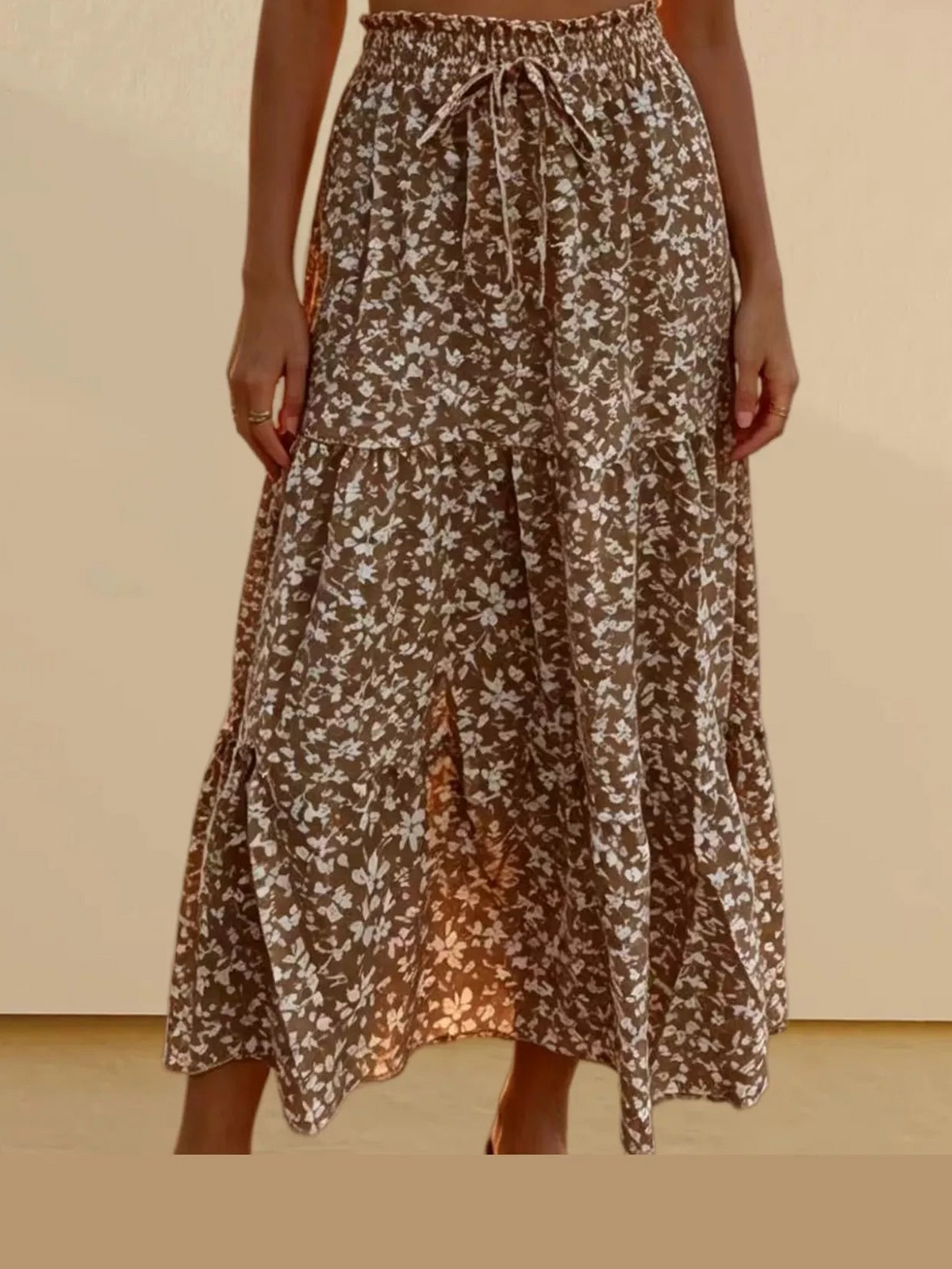 Brown floral tiered midi skirt with elastic waistband and tie drawstring, layered ruffle hem.