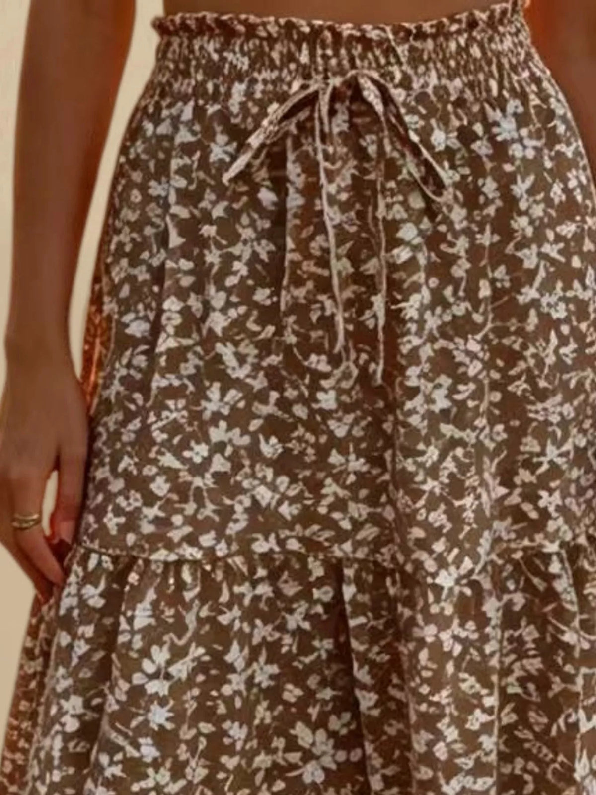 Brown and white floral tiered midi skirt with elastic waistband and front tie drawstring.