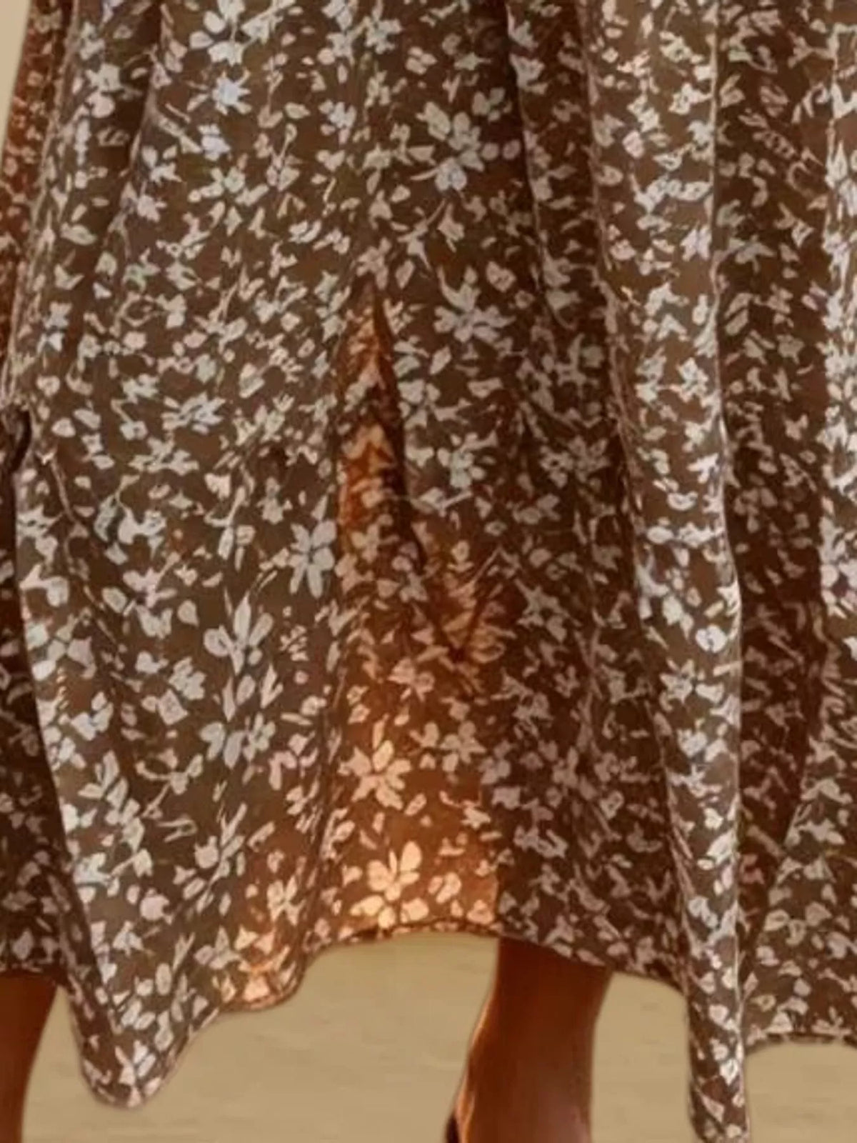 Brown floral tiered midi skirt with tie waist and tiered ruffle pattern.