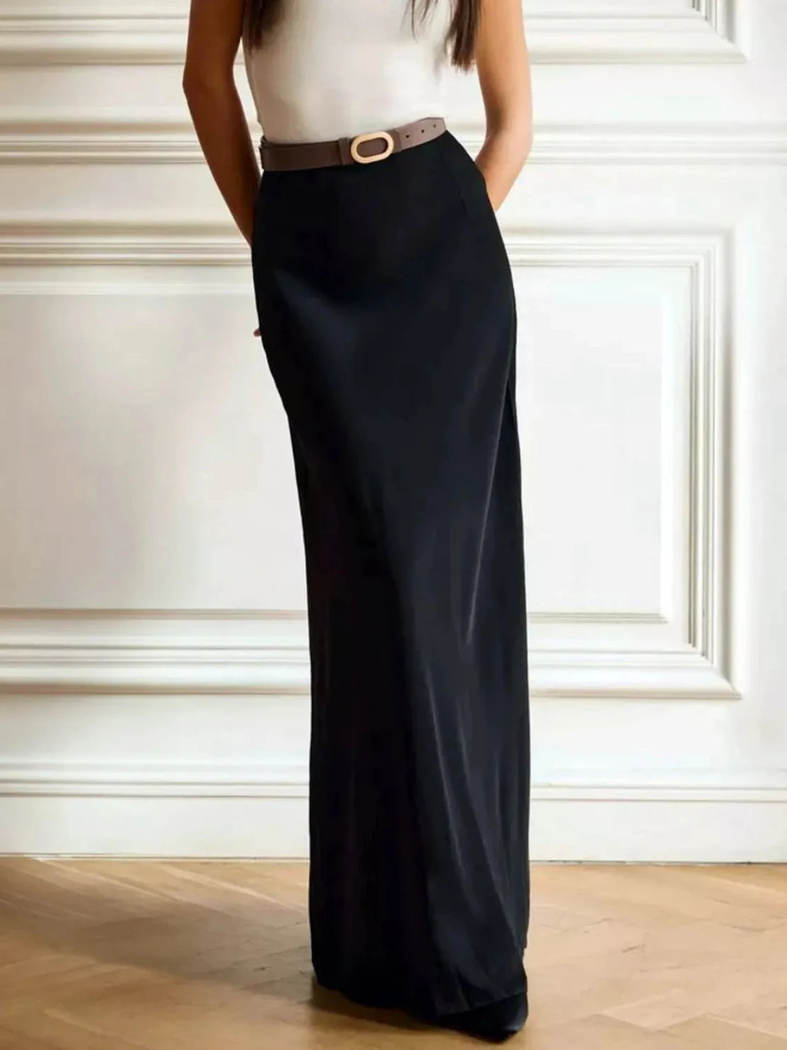 Black high-waisted maxi skirt with belt loop detail and long flowing shape