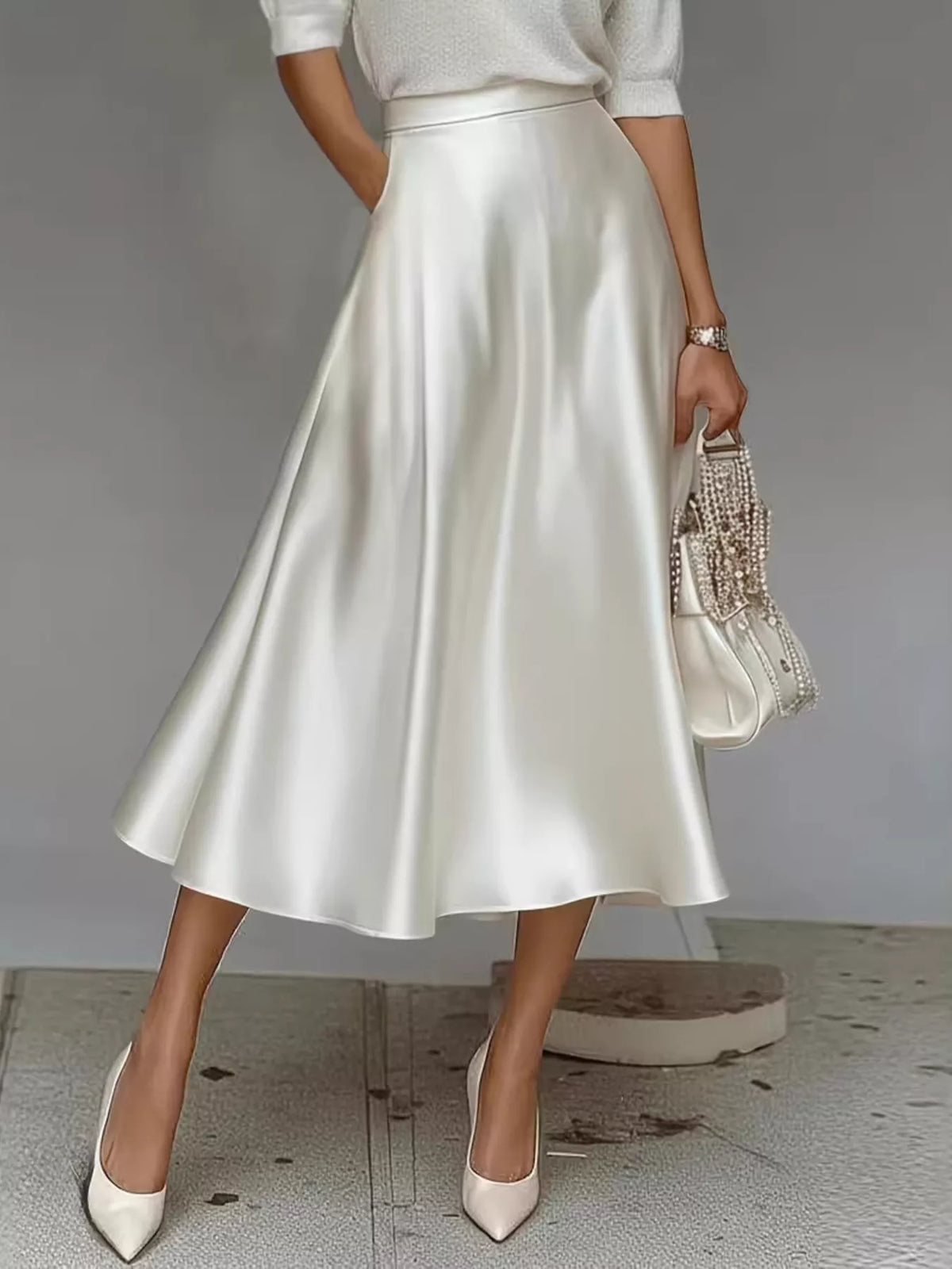 White satin midi skirt with a high waist and flowing A-line hem.