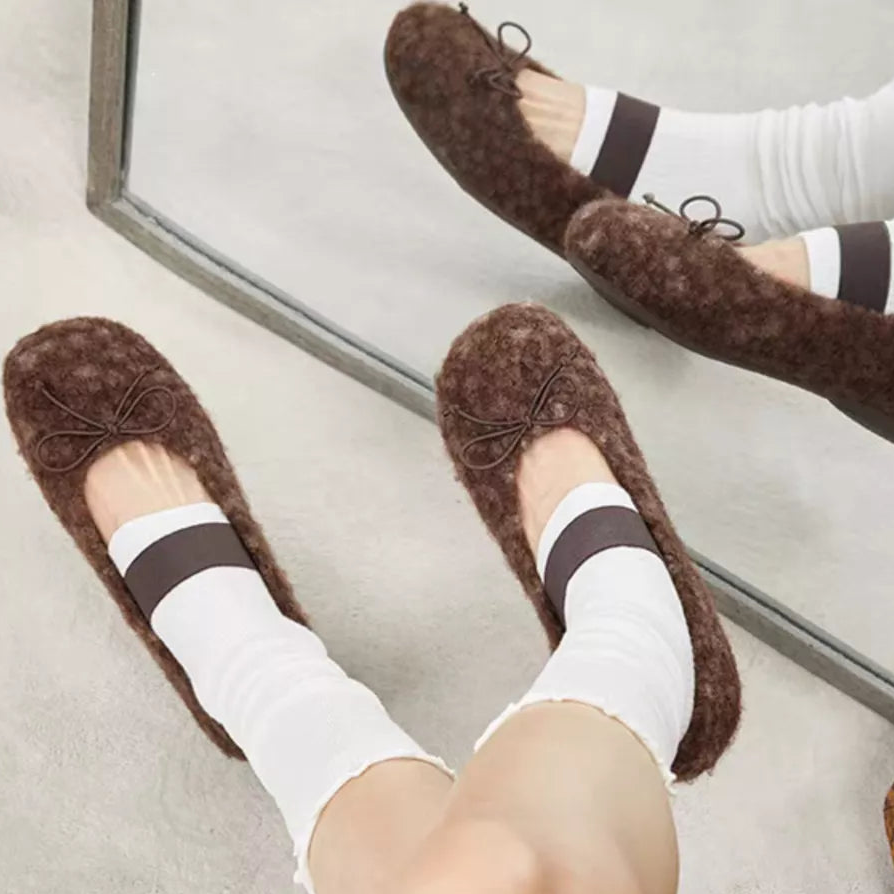 Coffee-brown faux fur slip-on flats with dark band and bow-tie eyelets