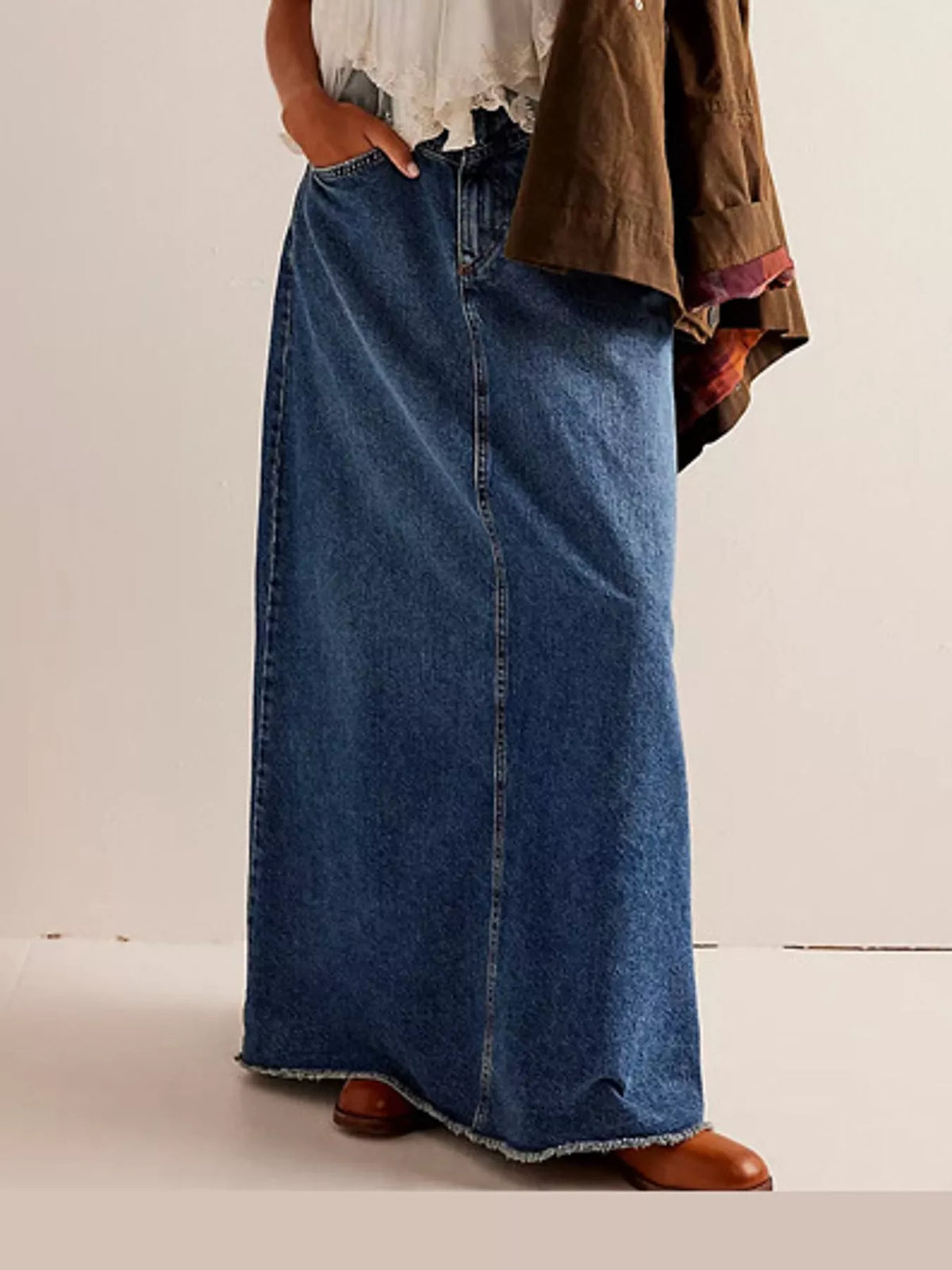 Dark blue maxi denim skirt with button front, patch pockets, and raw frayed hem