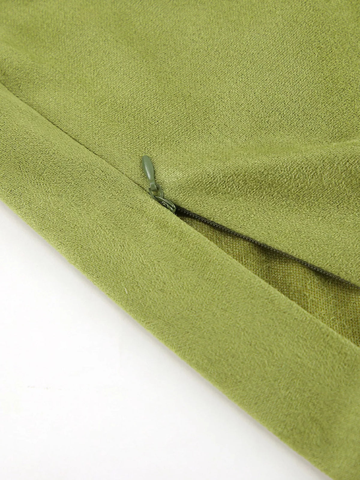 Matcha green skirt close-up showing a concealed zipper and fabric texture.